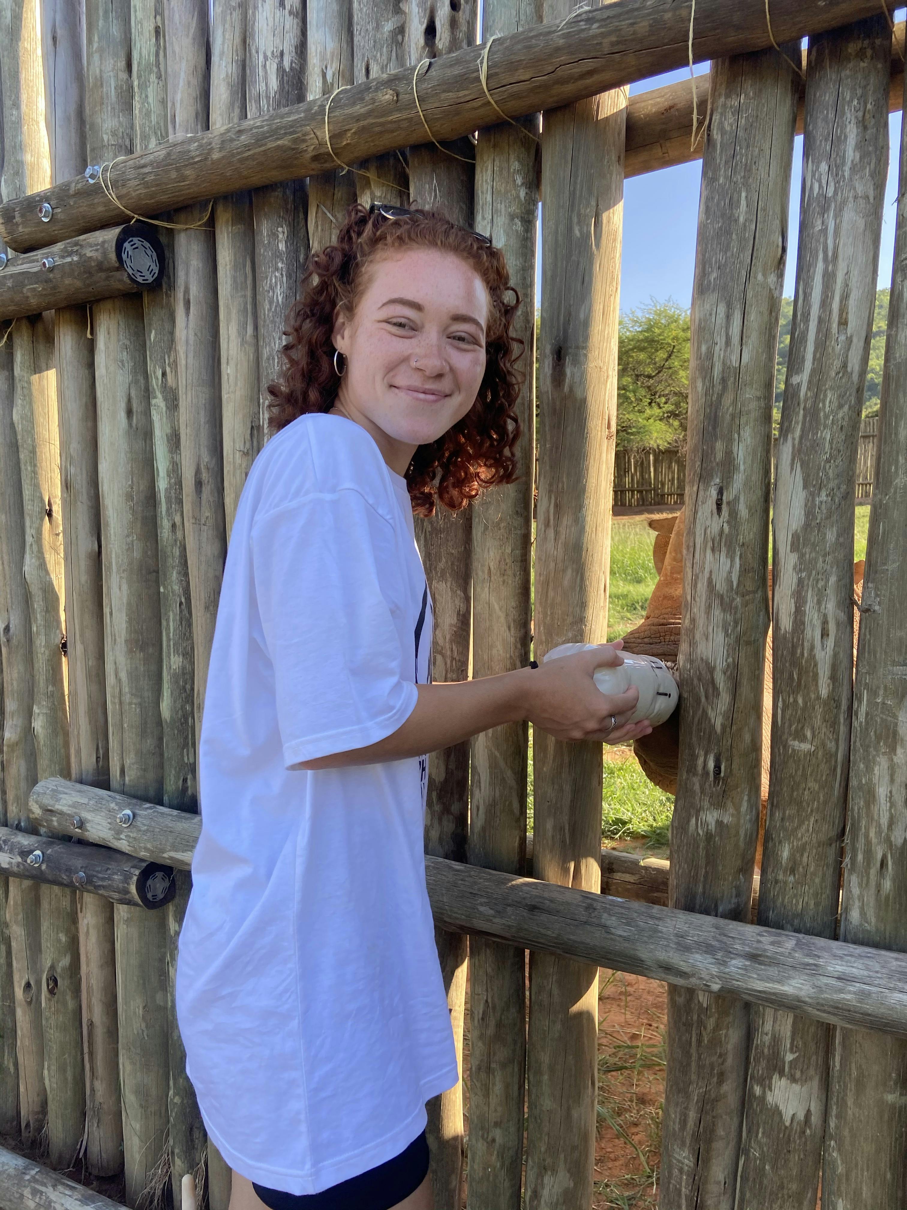 Sabrina Roach: profile photo, bottle feeding a rhino