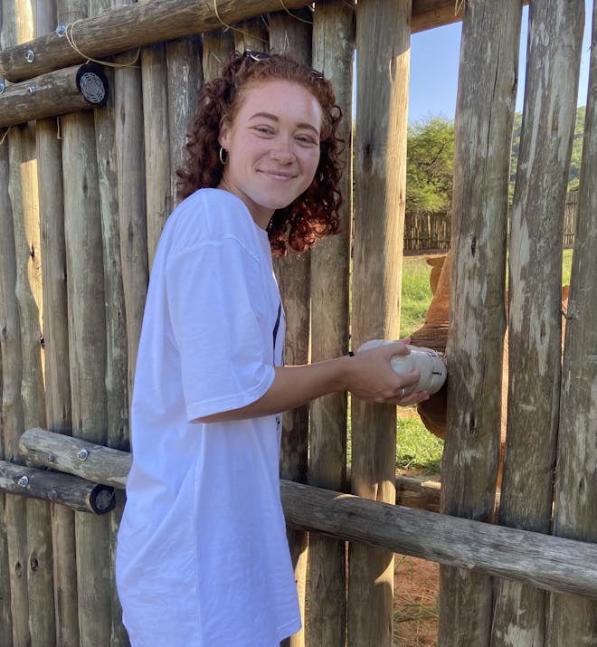 Sabrina Roach: profile photo, bottle feeding a rhino