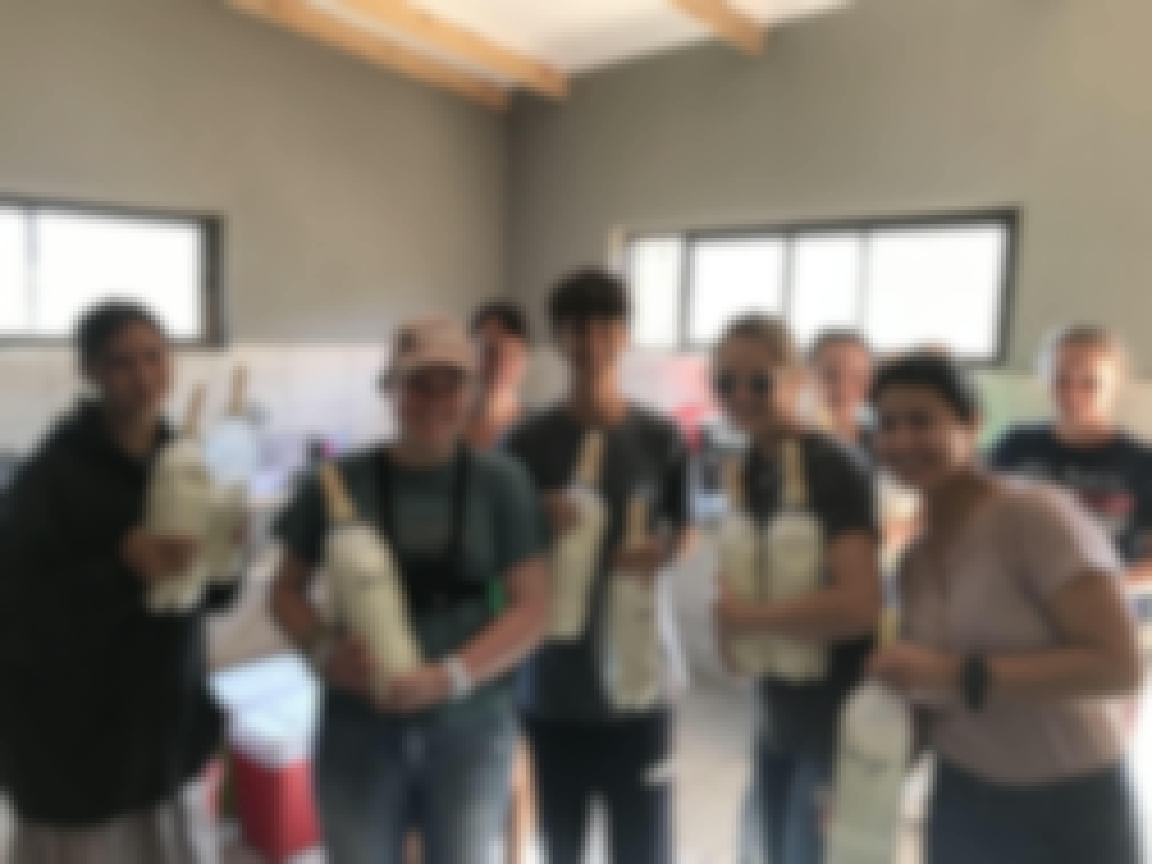 Nina Kubicek: group posing with bottles of formula for rhinos