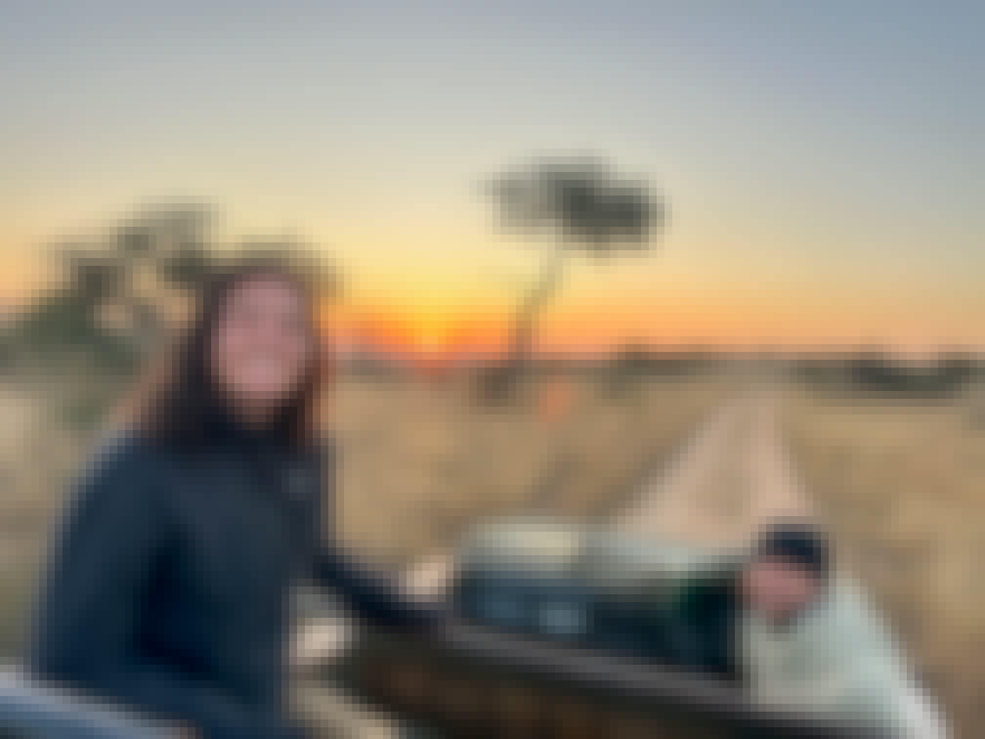 Volunteer posing on a vehicle in the Kruger