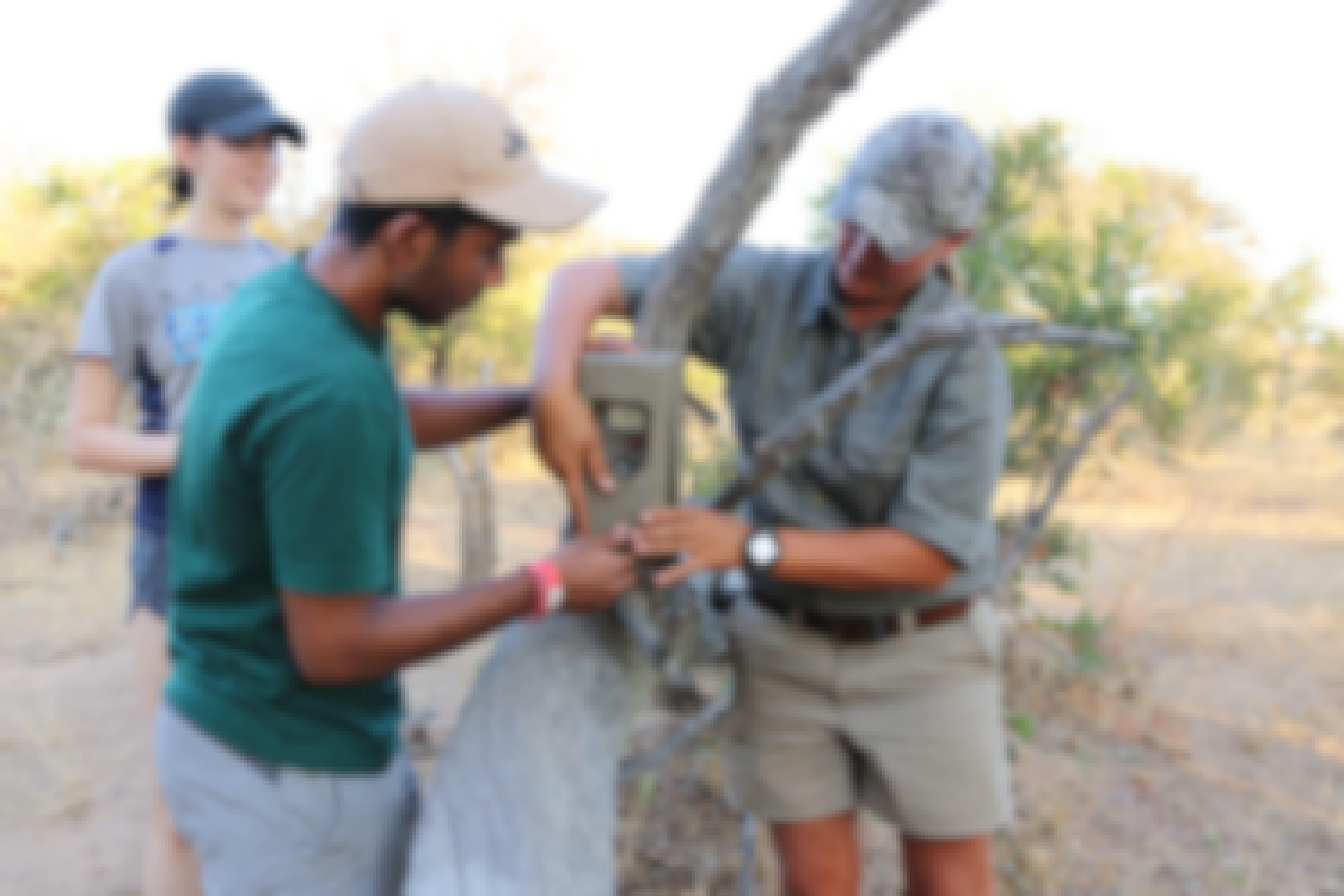 Volunteer setting up cameras with guide