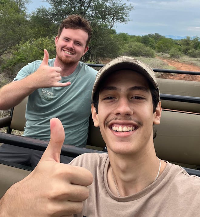 João de Oliveira: two male volunteers posing in a research vehicle
