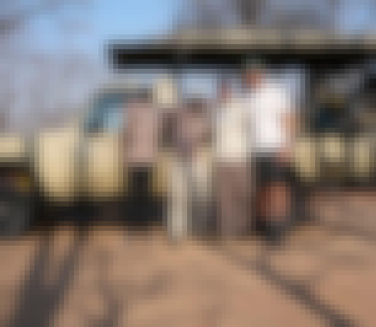 Sam Johnston: group of male volunteers smiling in front of a research vehicle 