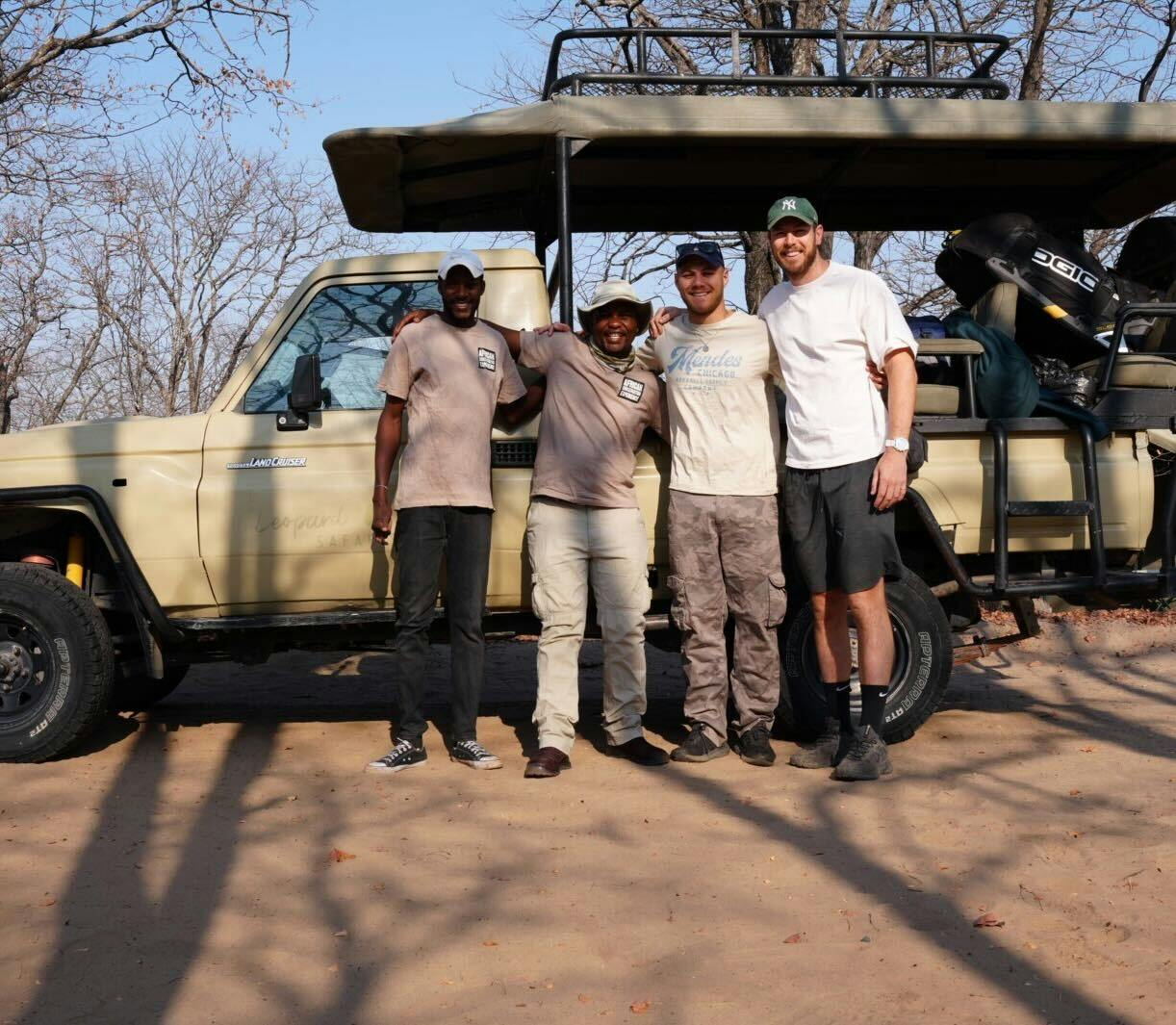 Sam Johnston: group of male volunteers smiling in front of a research vehicle