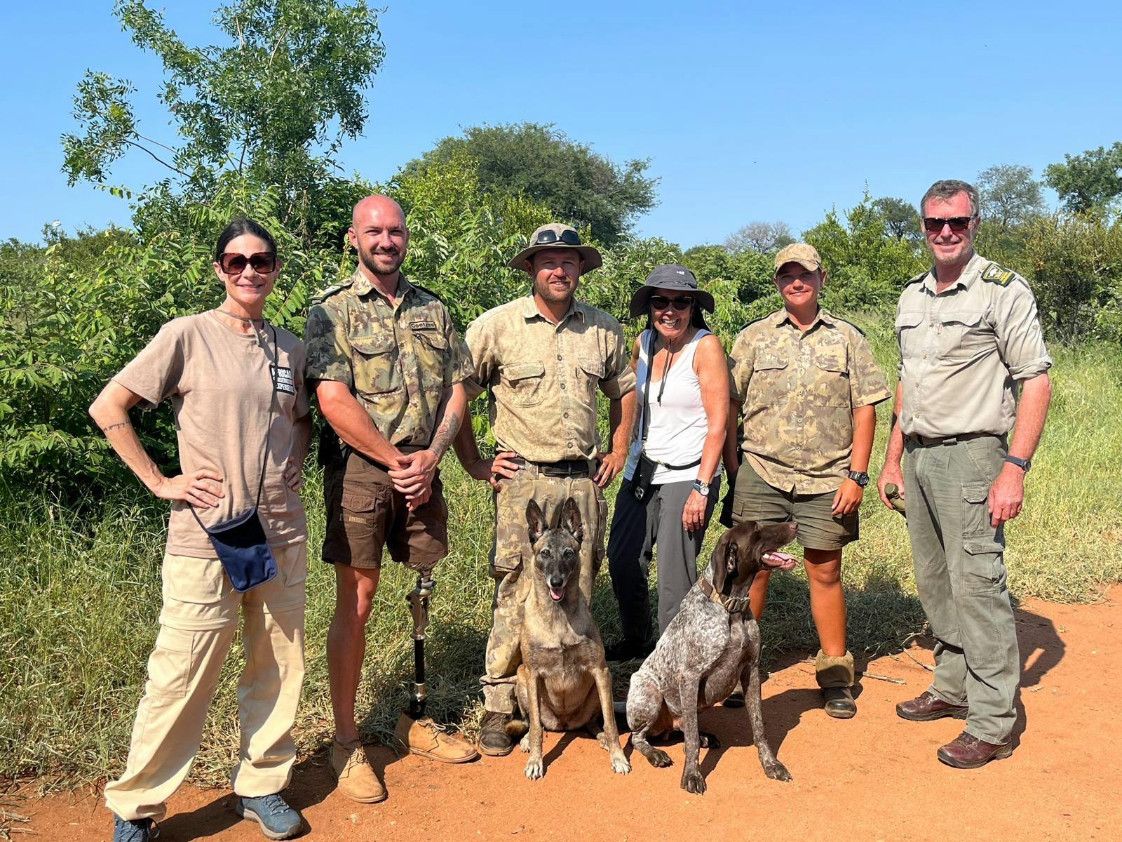Carrie Roussin: volunteers posing with the research team and the anti-poaching dogs
