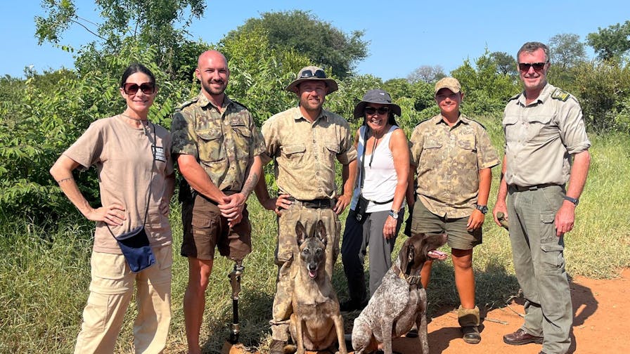 Carrie Roussin: volunteers posing with the research team and the anti-poaching dogs