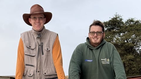 Amanda Thompson: two male volunteers posing on the back of the truck