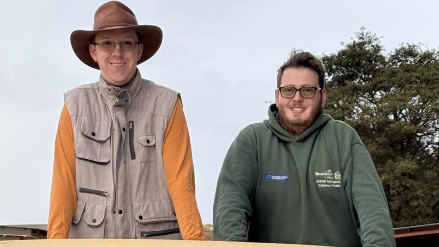 Amanda Thompson: two male volunteers posing on the back of the truck