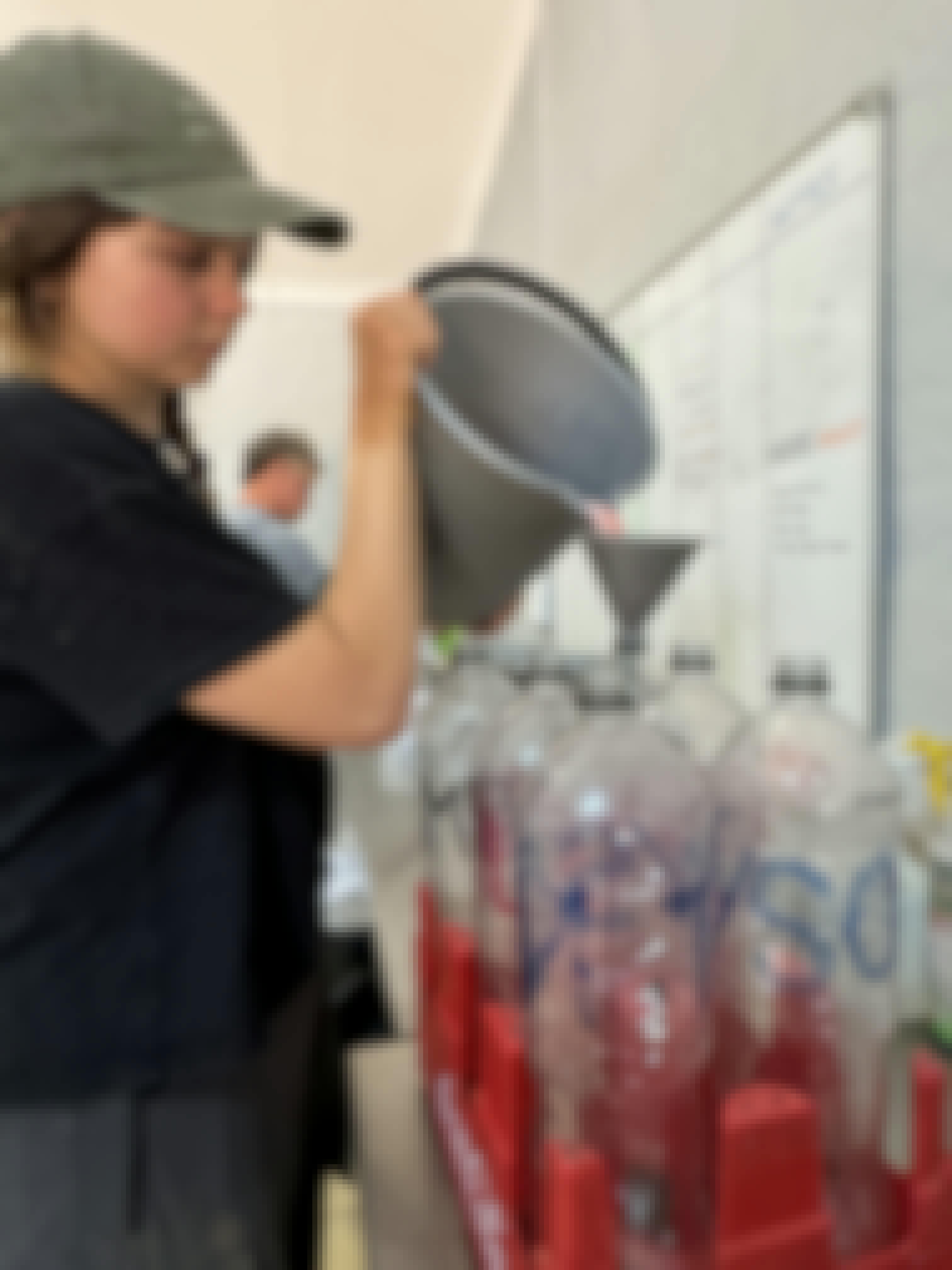 Amanda Thompson: female volunteer preparing milk for rhino calfs