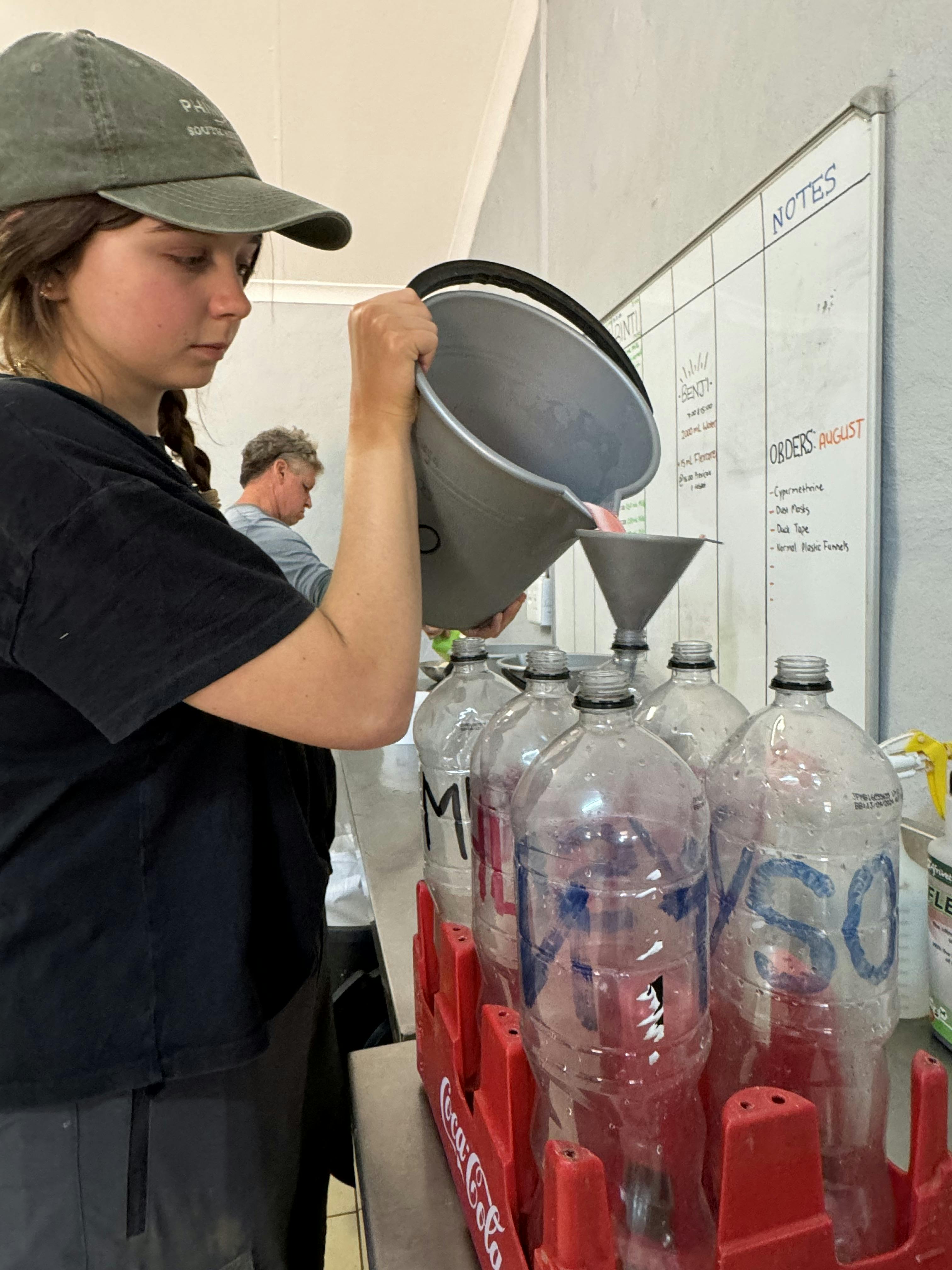 Amanda Thompson: female volunteer preparing milk for rhino calfs