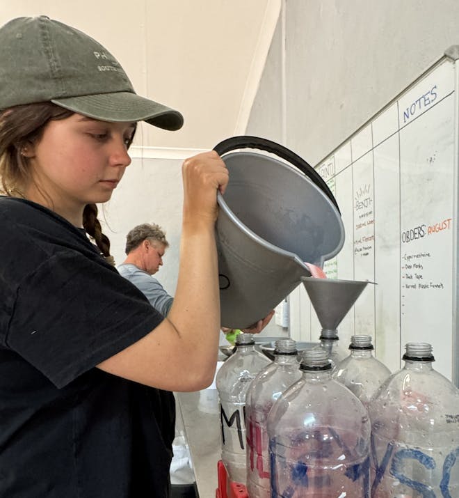 Amanda Thompson: female volunteer preparing milk for rhino calfs