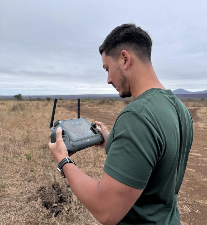 Adam Peerally: a male volunteer working a drone for research