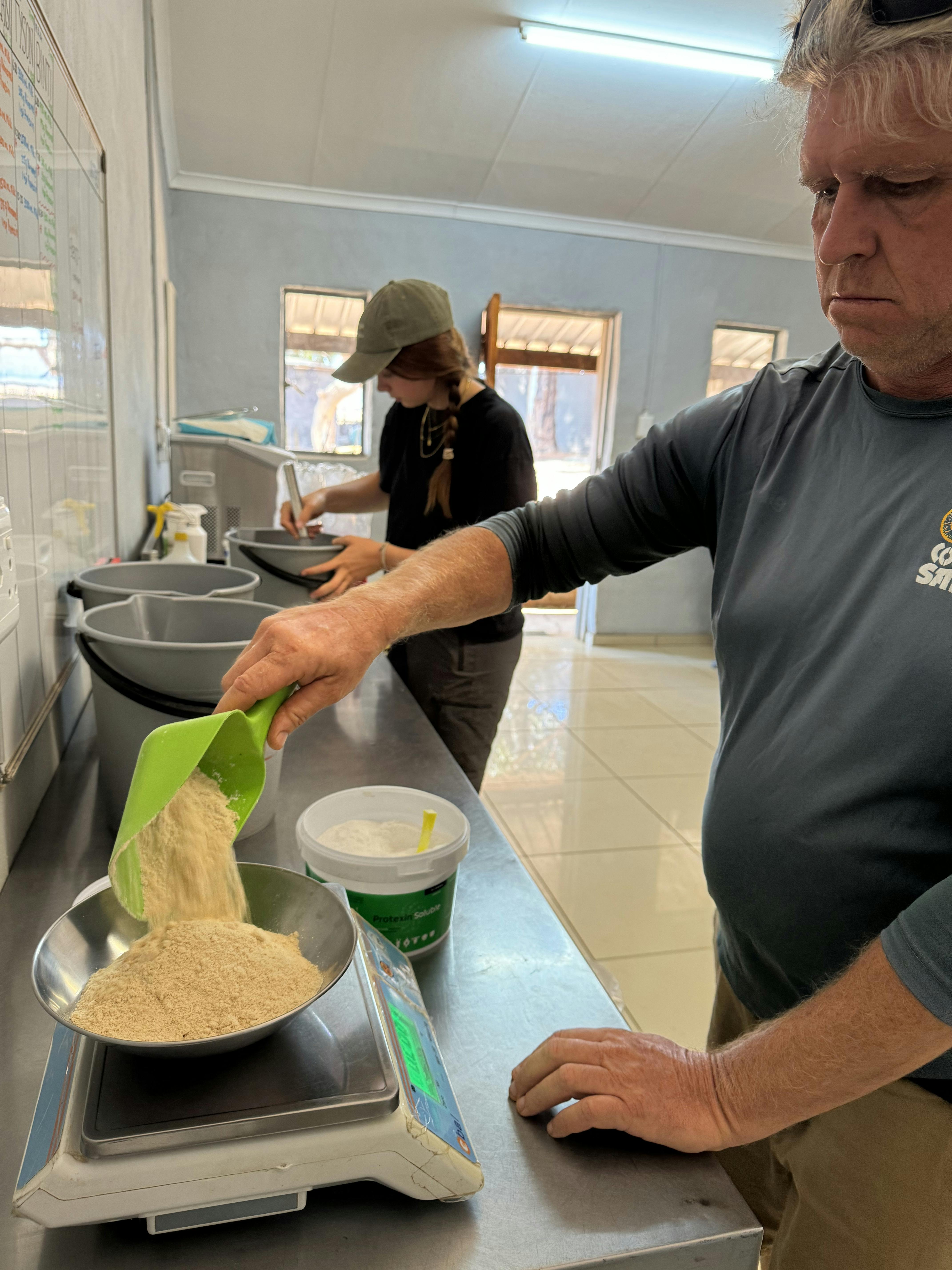 Amanda Thompson: a male volunteer prepare the rhino calf milk