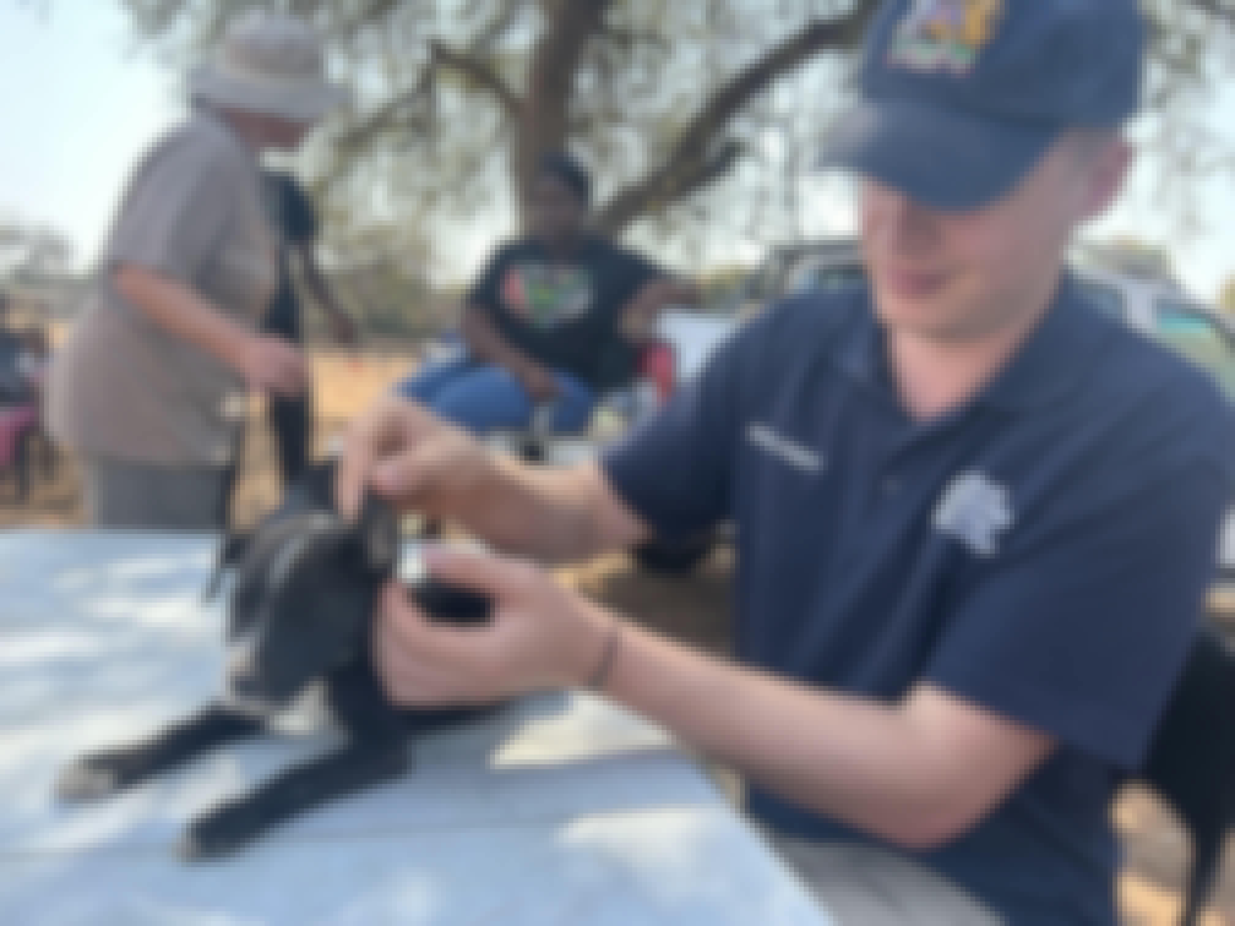 Matthew Gregory: male volunteer carrying out veterinary care on a puppy