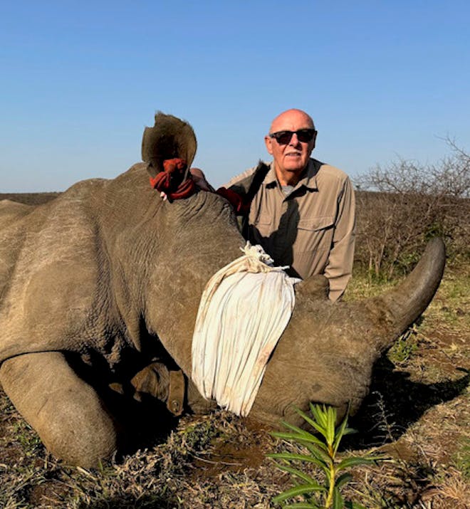 Maurice Tallantyre: close up of male volunteer with rhino having it's horn trimmed