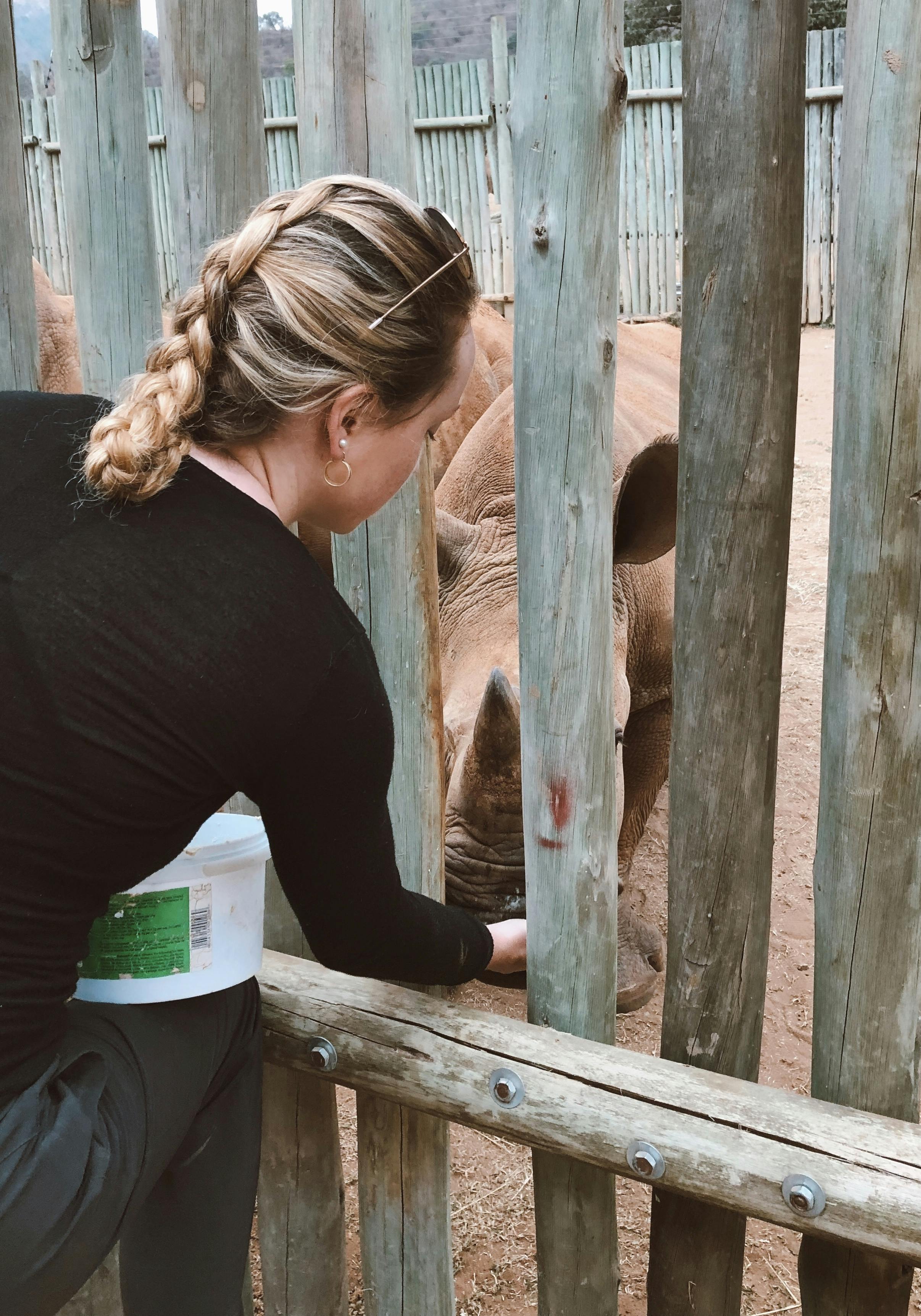Maisie Kane: bottle feeding a baby rhino