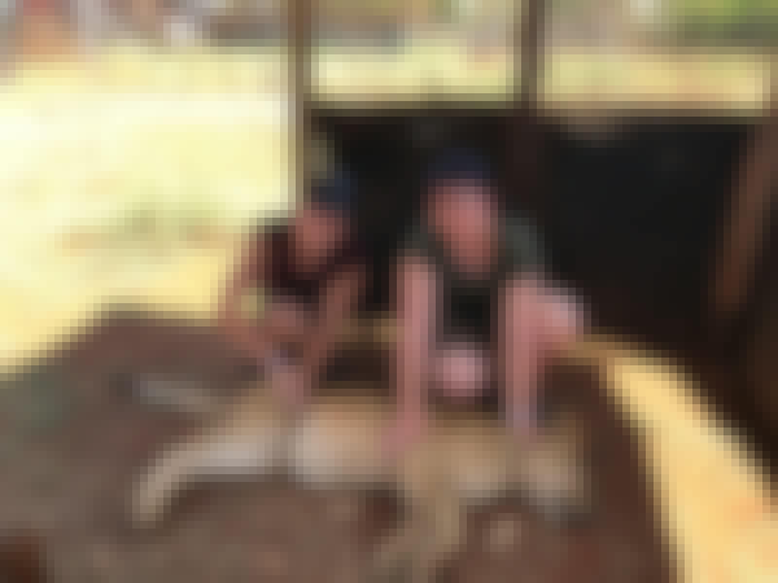 Emma Ruggles: posing with a friend next to a sedated lion