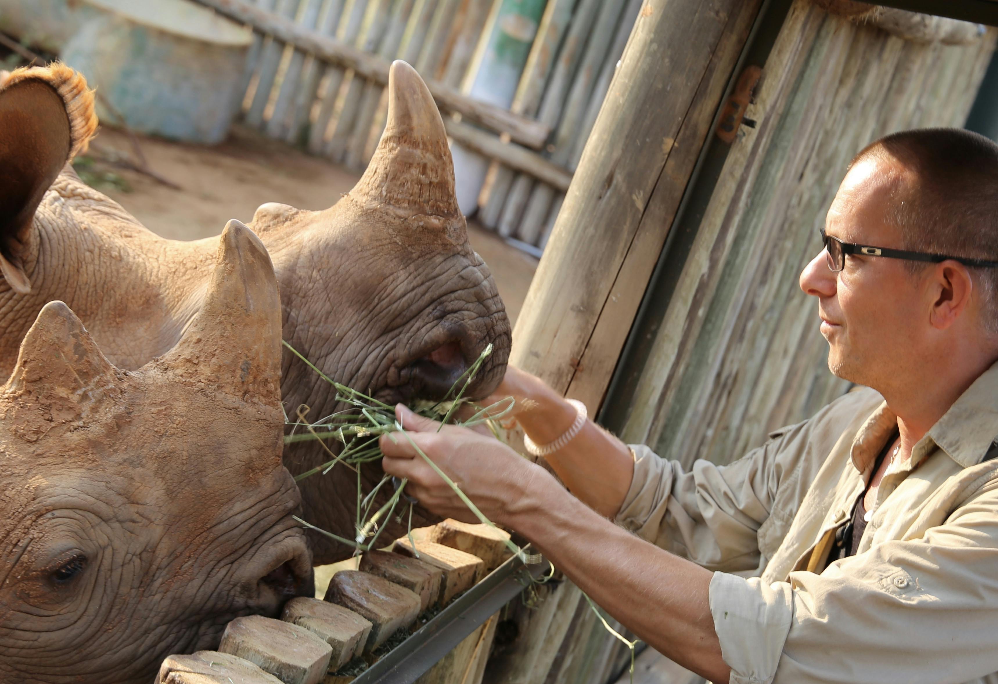 Martin and Julie While: Martin feeding rhinos at Care for Wild