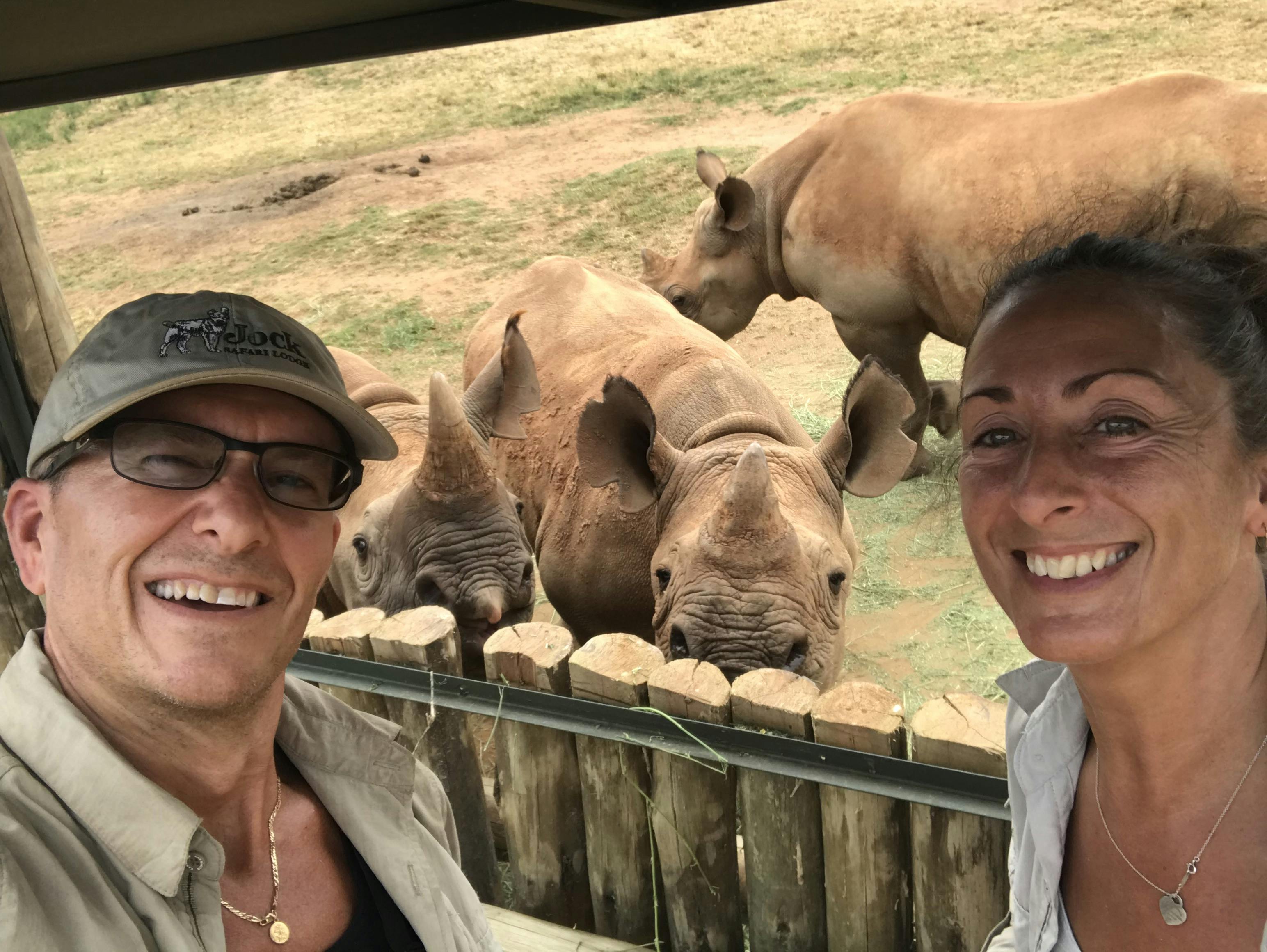 Martin and Julie While: posing with rhinos in the background