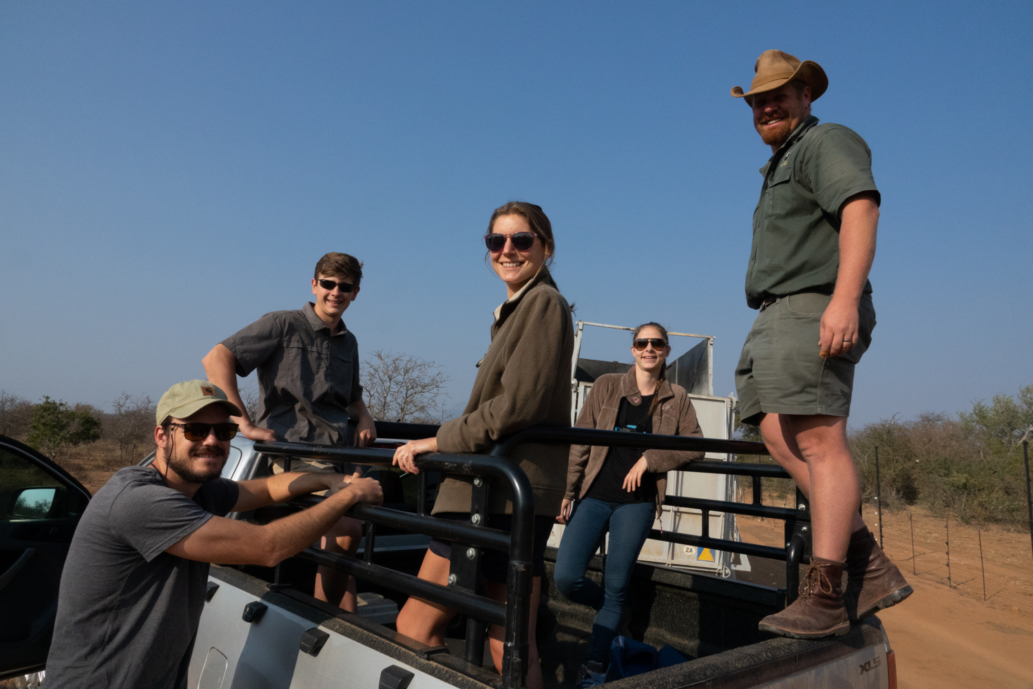 Benedict King: group posing on a vehicle