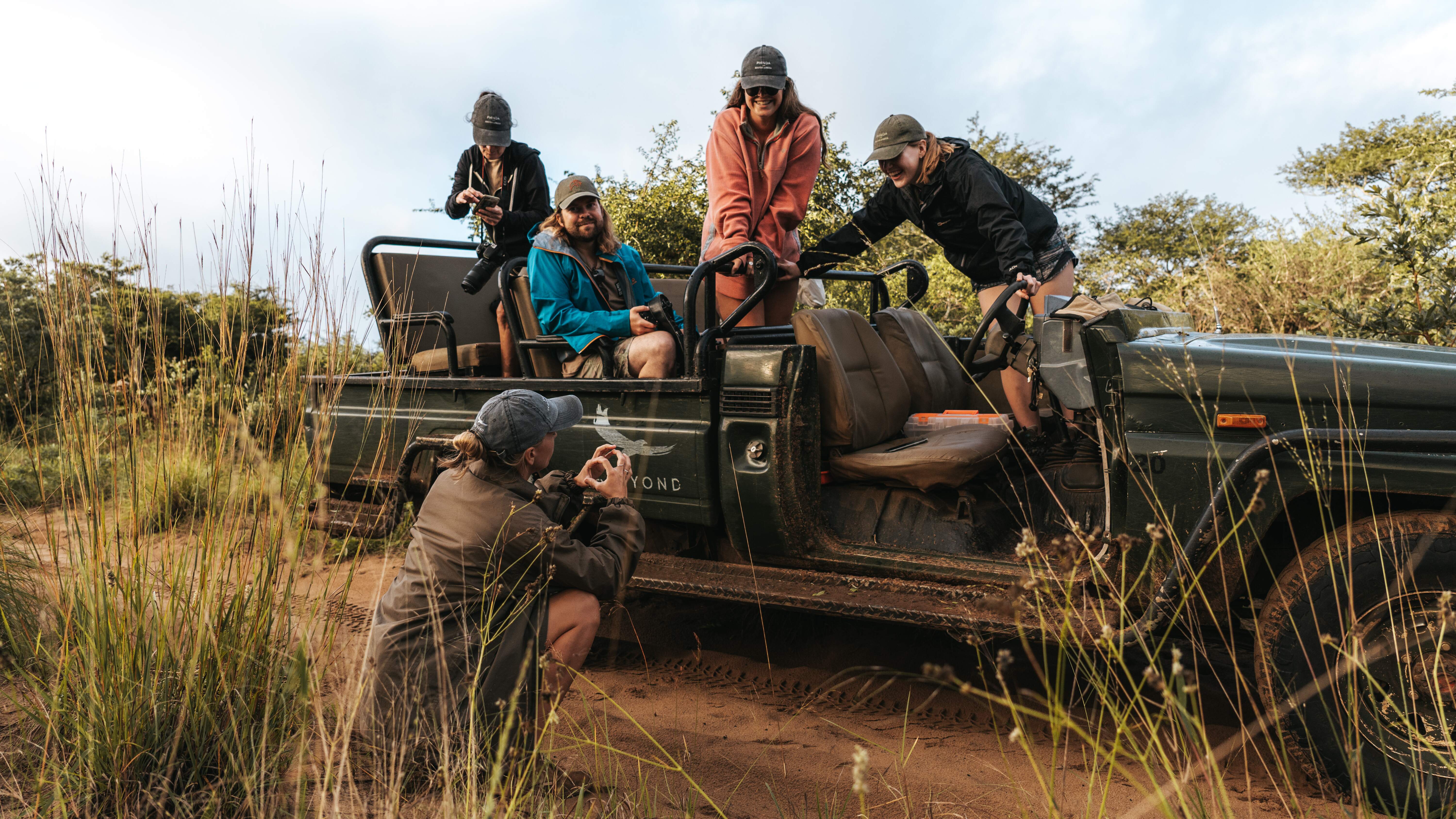 Conservation research volunteer - Wildlife Research and Management - Group of ACE students posing atop a vehicle