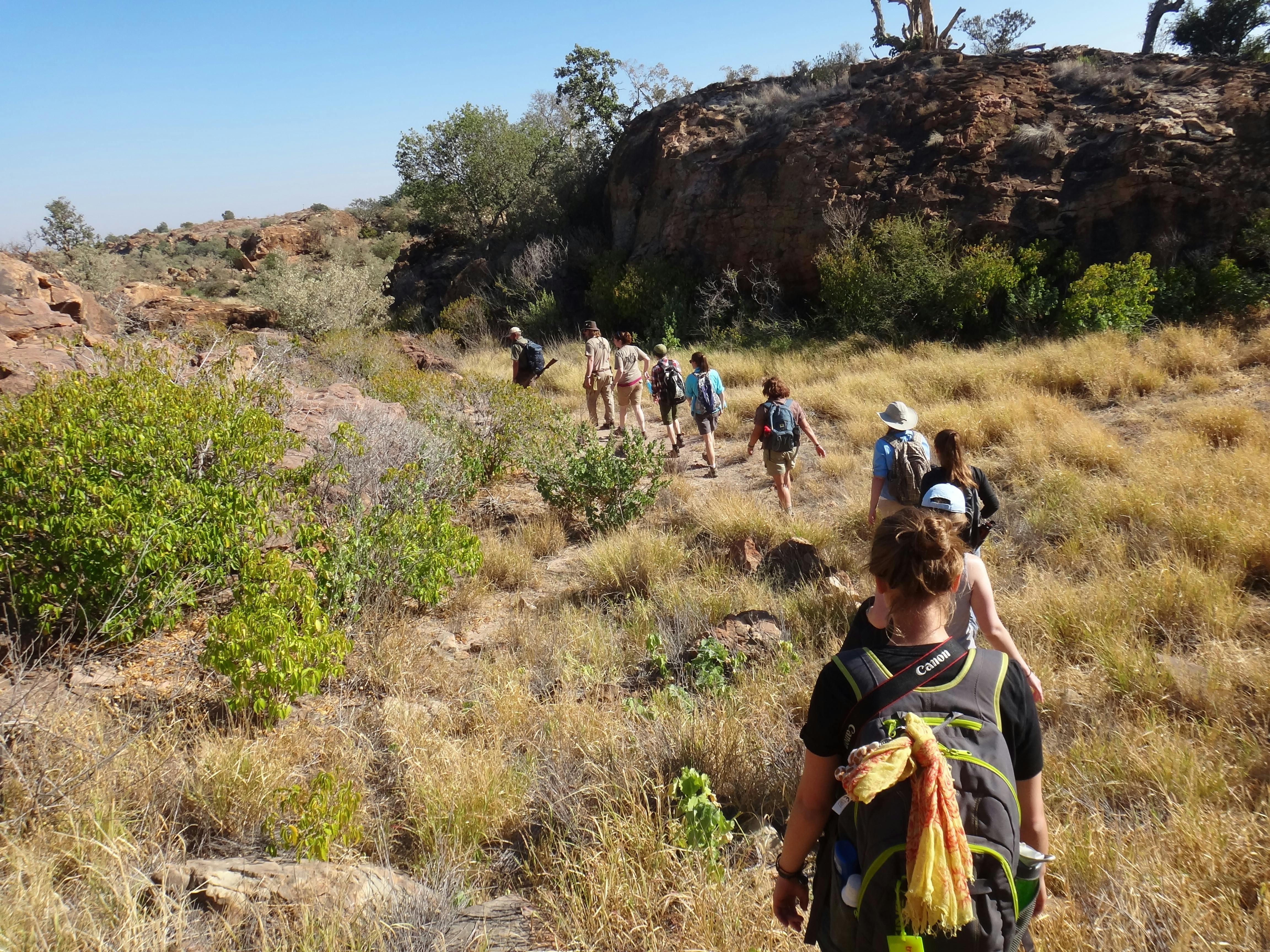 A group of students and teachers hiking through the plains