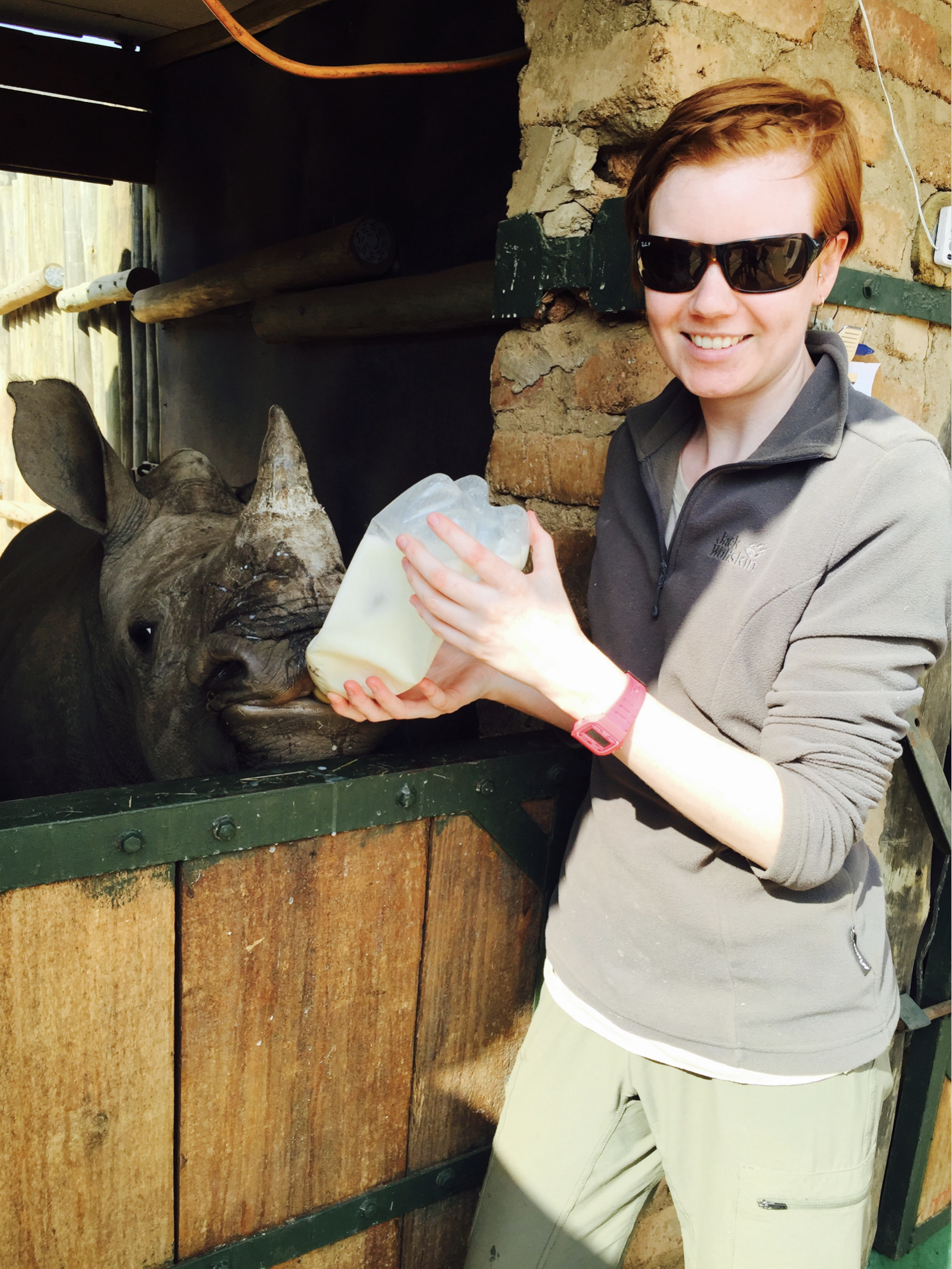 Jessica Gunn bottle feeding a rhino