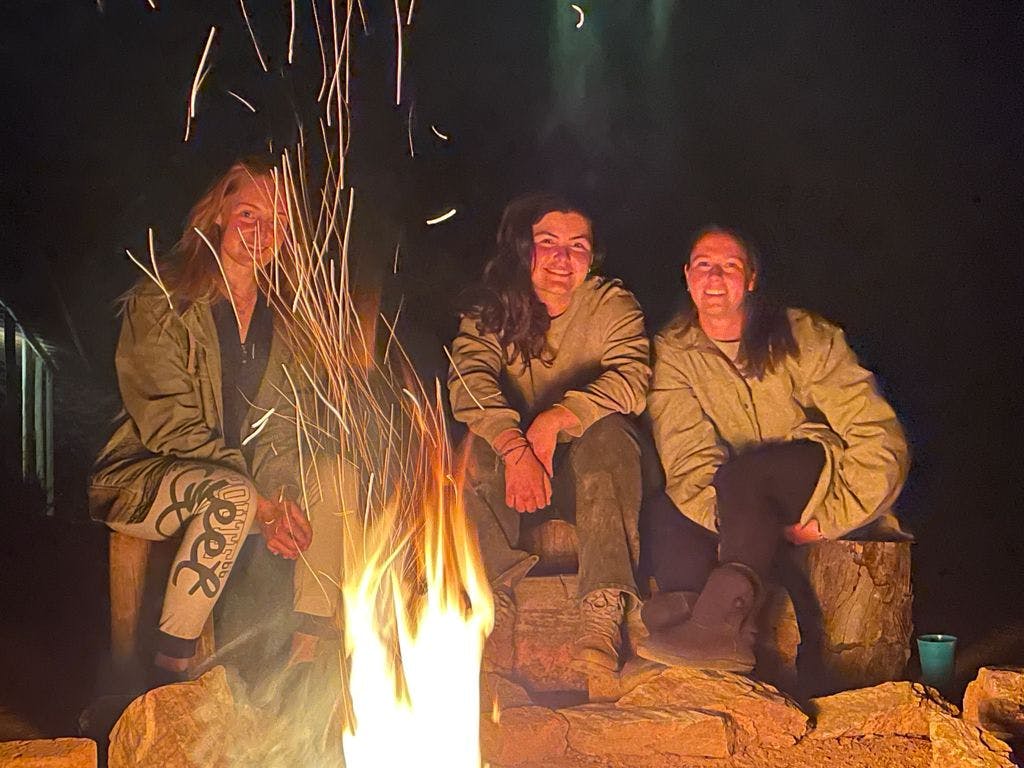 Vet student group relaxing by the campfire