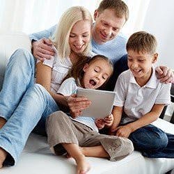 A family looking at something on the couch