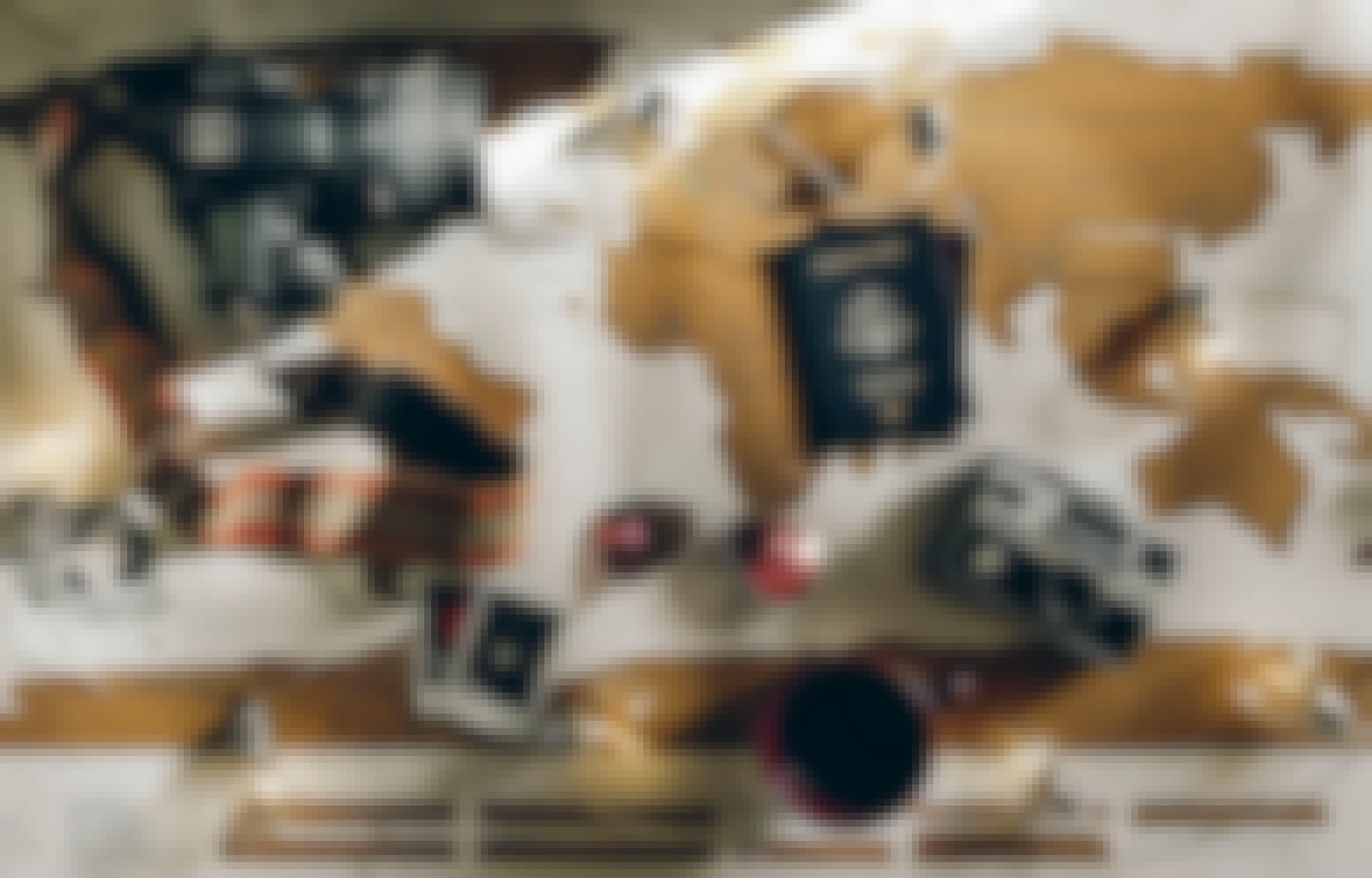 A map of the world on a desk with a passport, sunglasses, cameras and other objects scattered on top