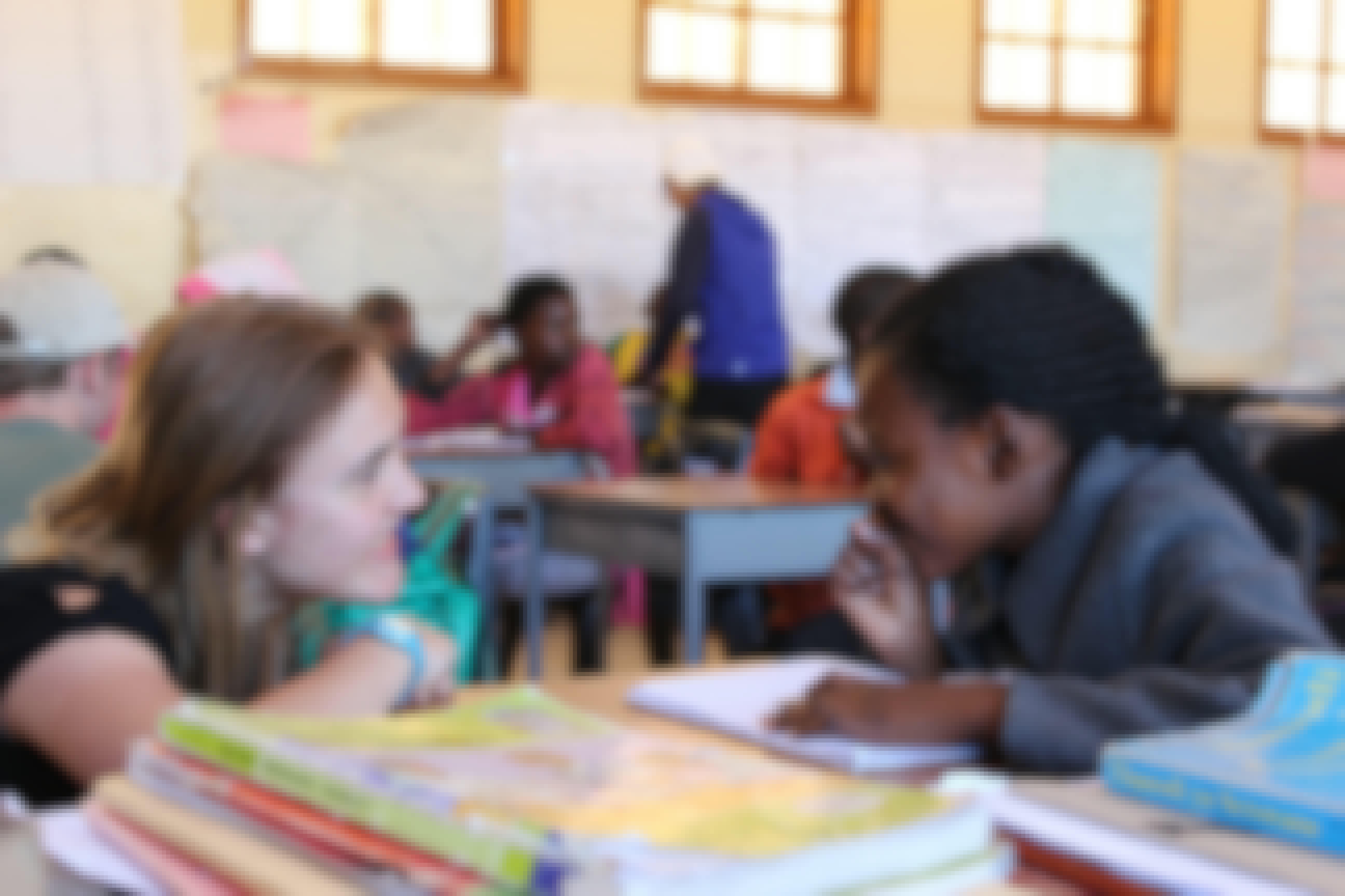 An ACE student in a classroom helping to teach children