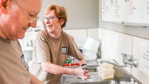 Wildlife rehabilitation volunteer opportunities - Wildlife Care & Rehabilitation - Man and women smiling whilst cleaning bottles