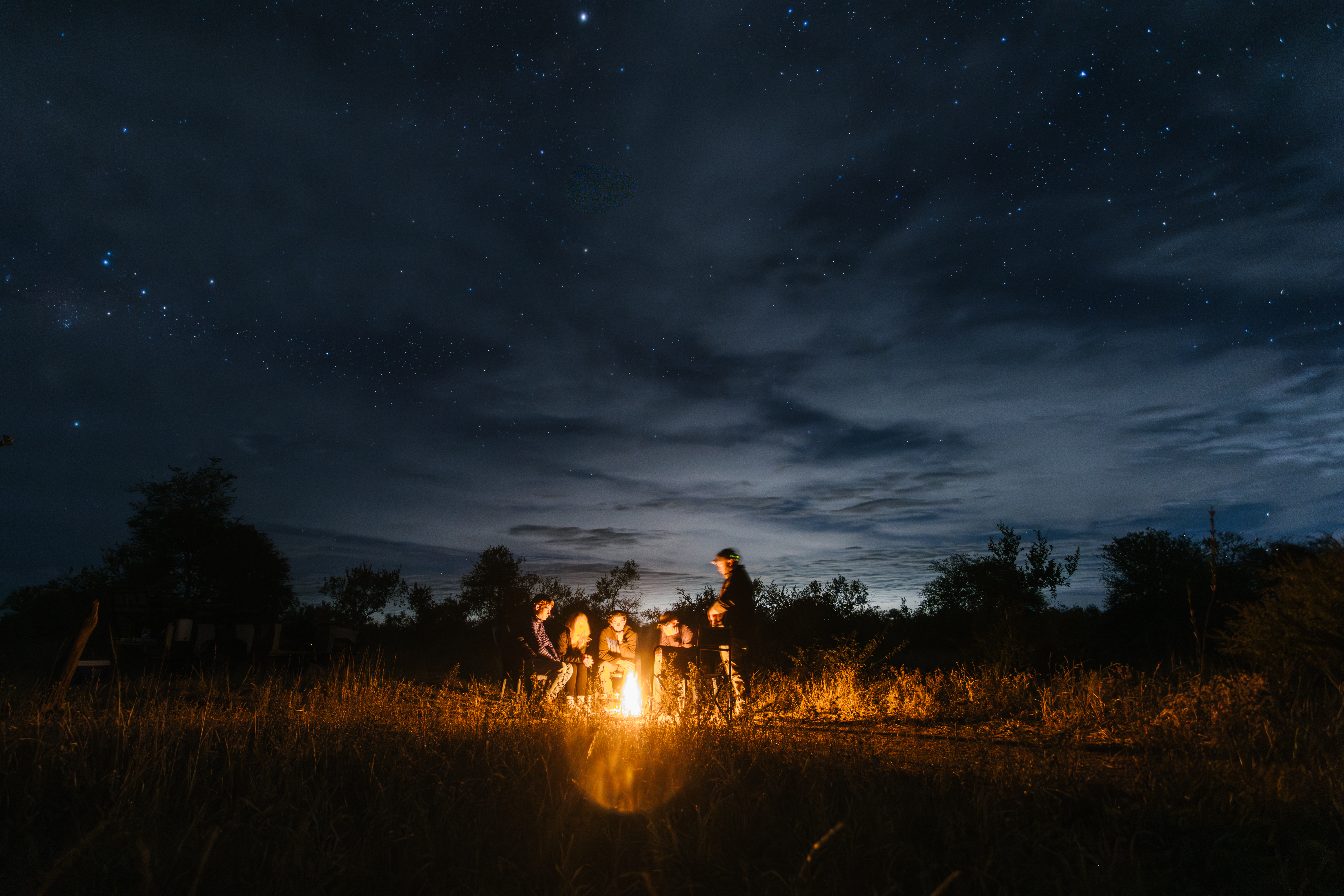 Volunteer Abroad - Volunteering Experiences - Group of volunteers around the campfire in the Kruger