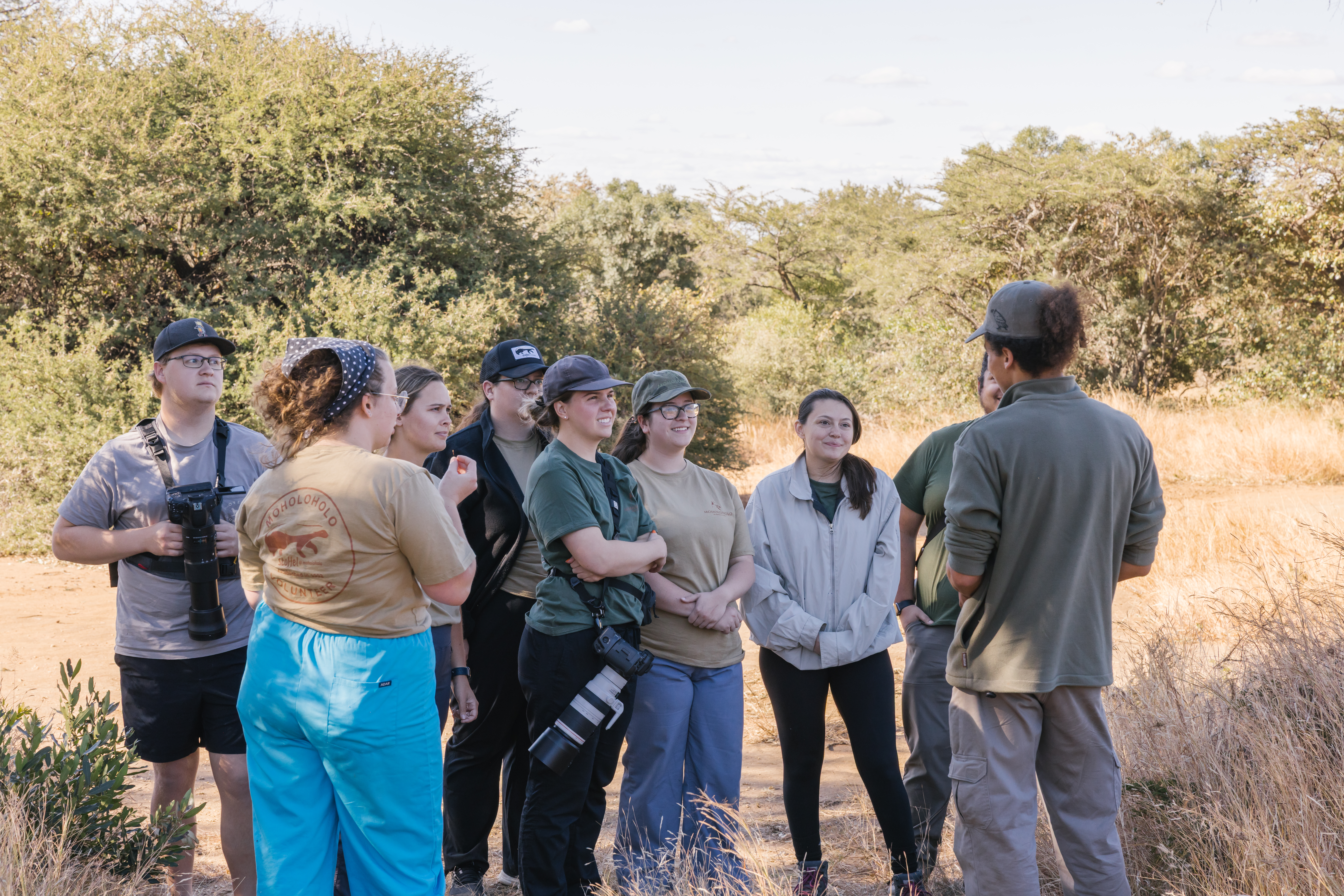 Lion conservation volunteer - Lion conservation experiences - Group listening to a guide in the bush