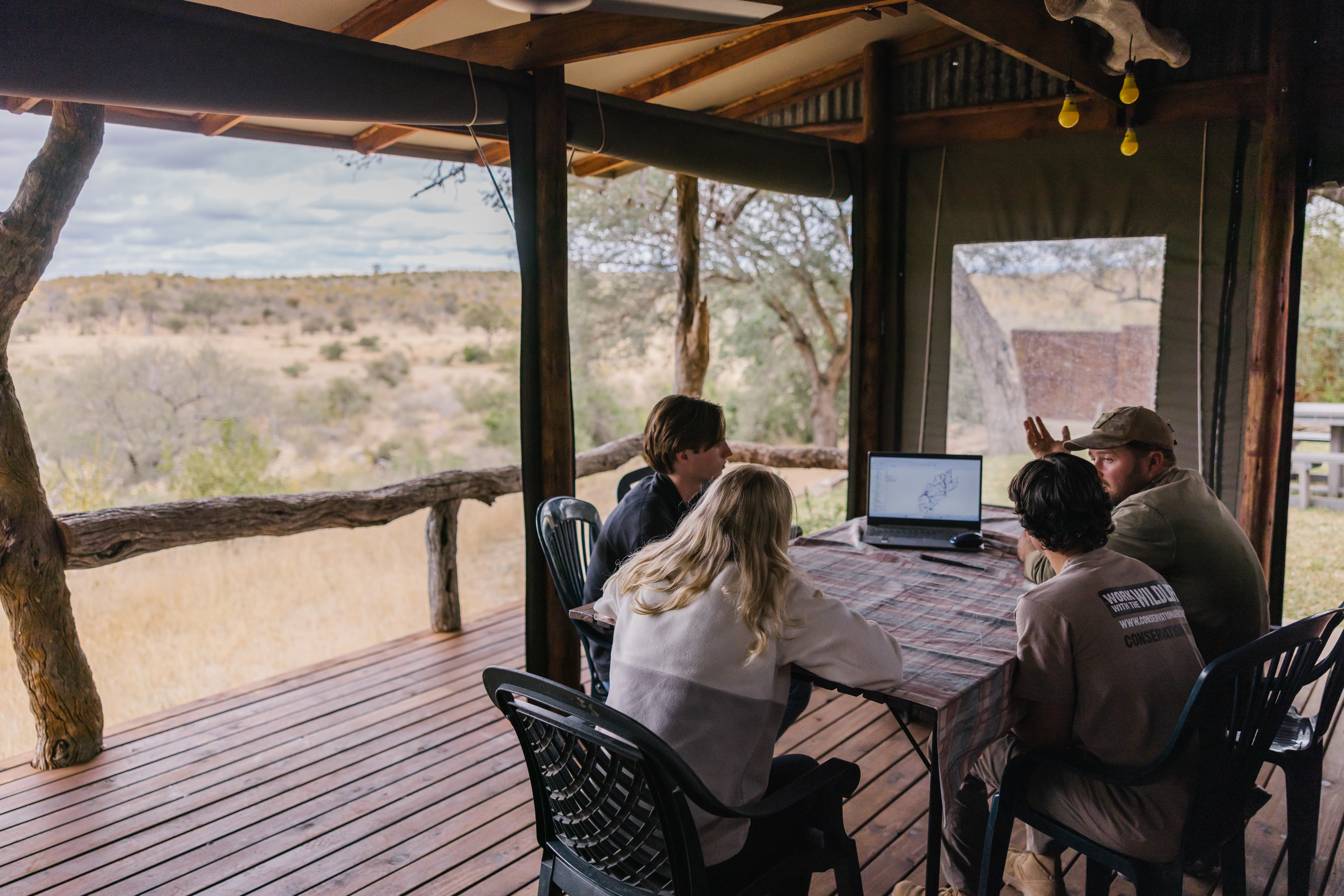 Best volunteer abroad programs - Recommended volunteer experiences - Group of volunteers looking at their recorded wildlife data on a computer 