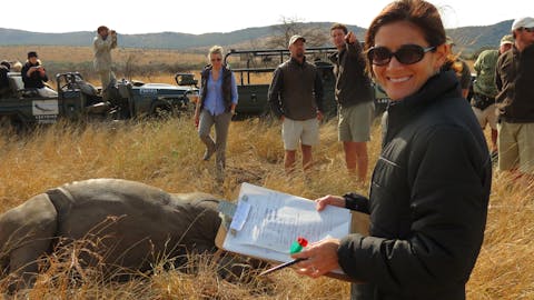 Short term volunteer work abroad - Short term volunteer work - Volunteer smiling whilst data recording in the bush