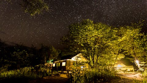 Okavango Wilderness Project - camp tents under the stary night sky