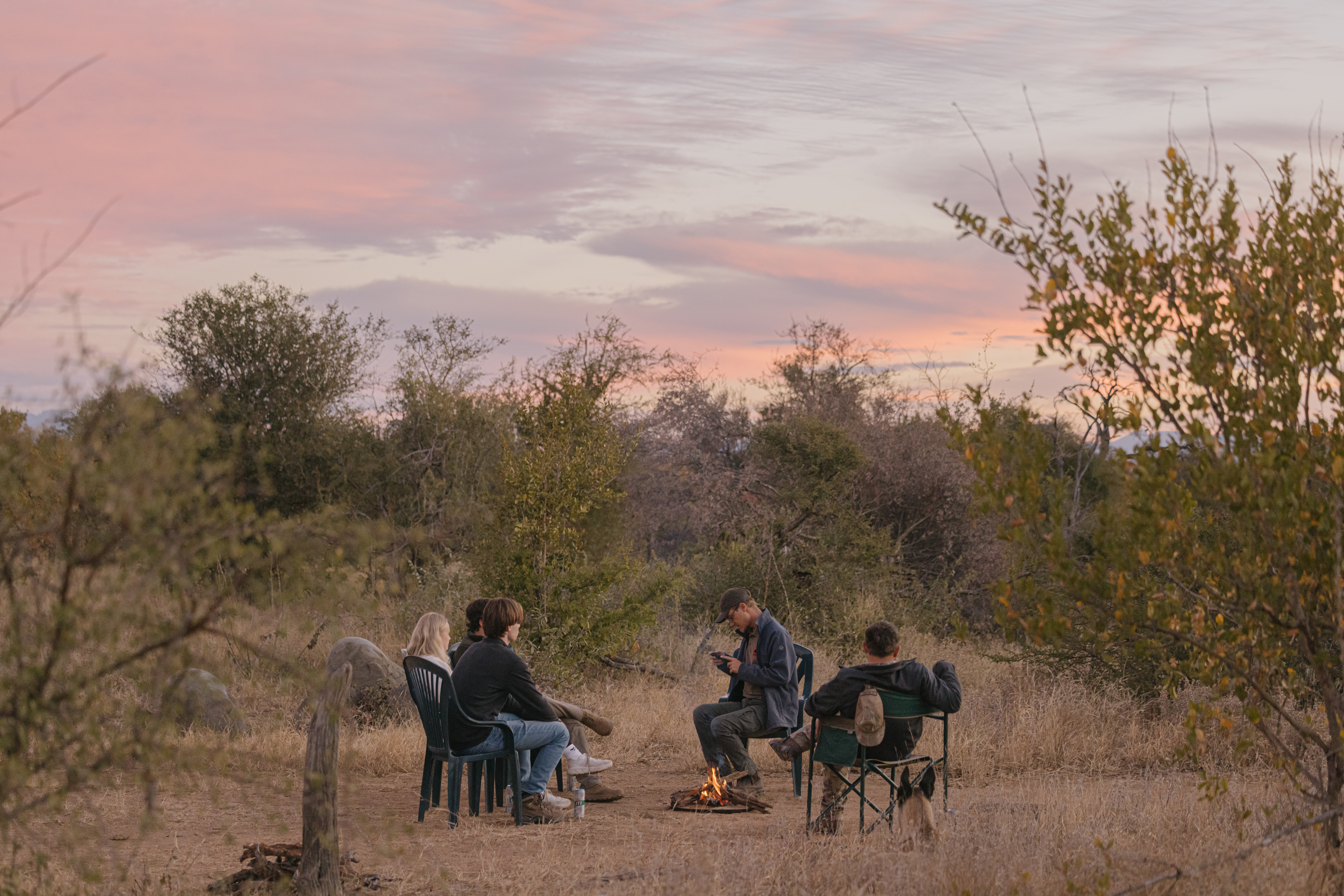 From Famous Kruger to Remote Okavango - volunteers relaxing by a small campfire