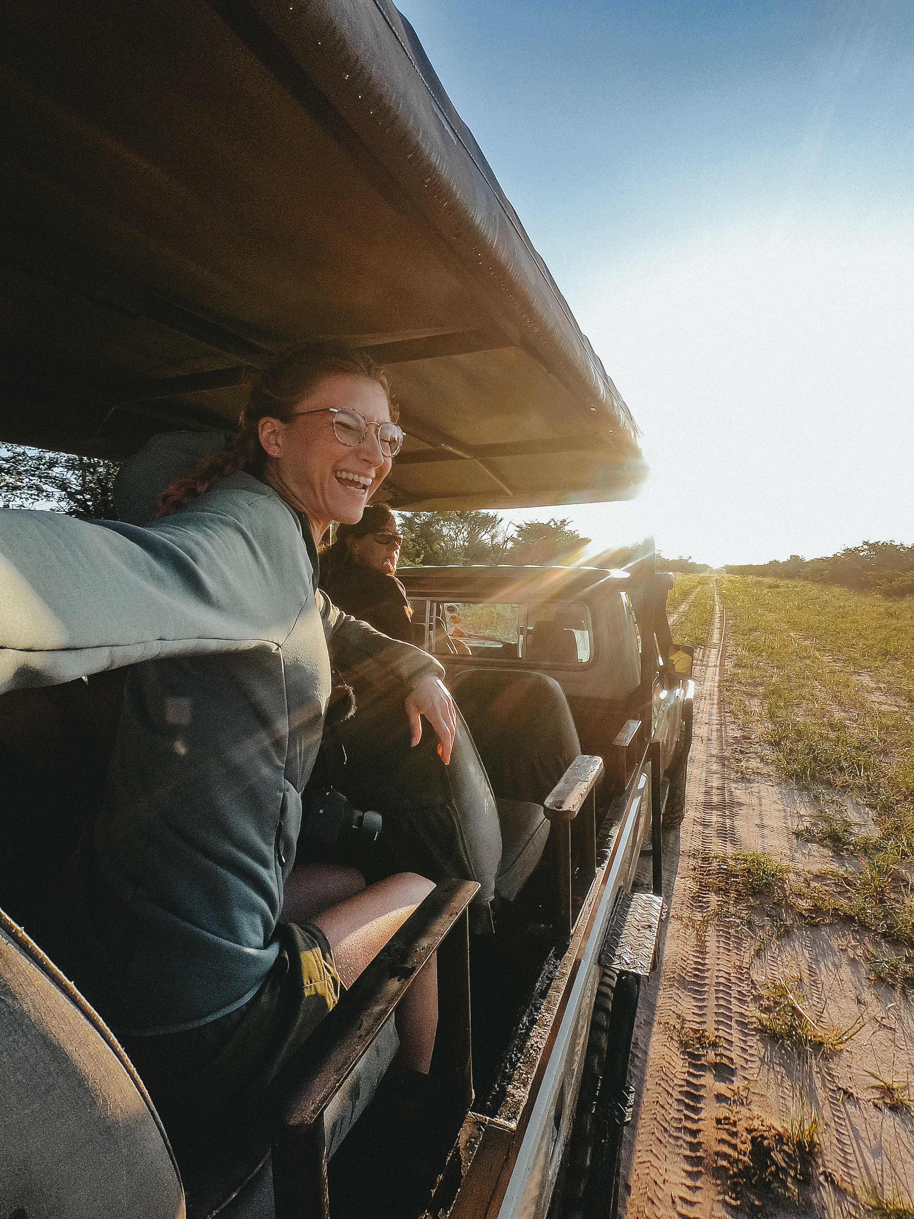 From Famous Kruger to Remote Okavango - volunteer posing in a driving vehicle 