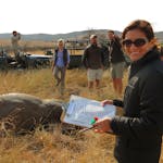 New Horizons Sabbatical - volunteer smiling at the camera whilst making notes on a rhino horn trimming