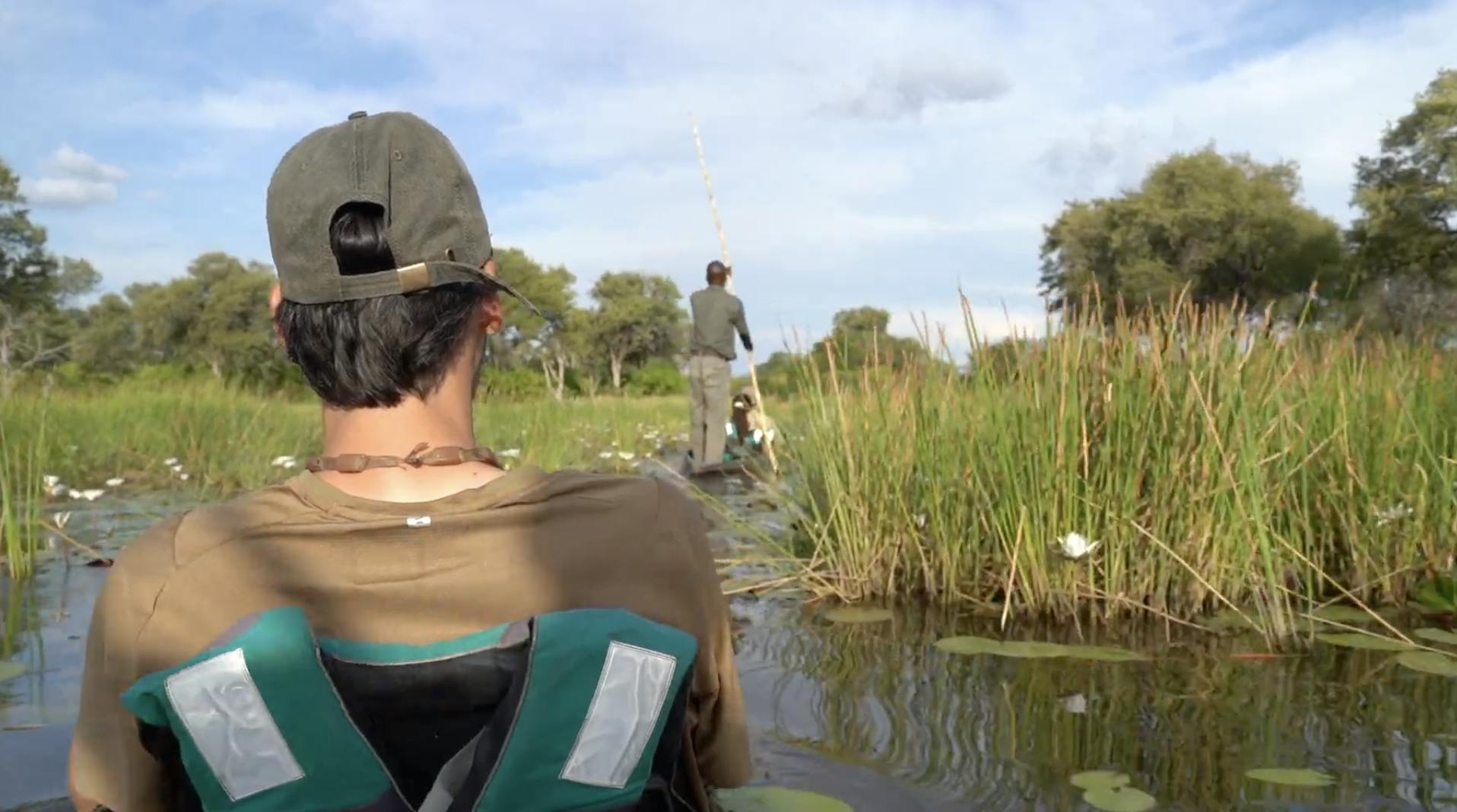 African wildlife adventures - Longer African wildlife adventures - Man gliding down the Okavango Delta in a mokoro