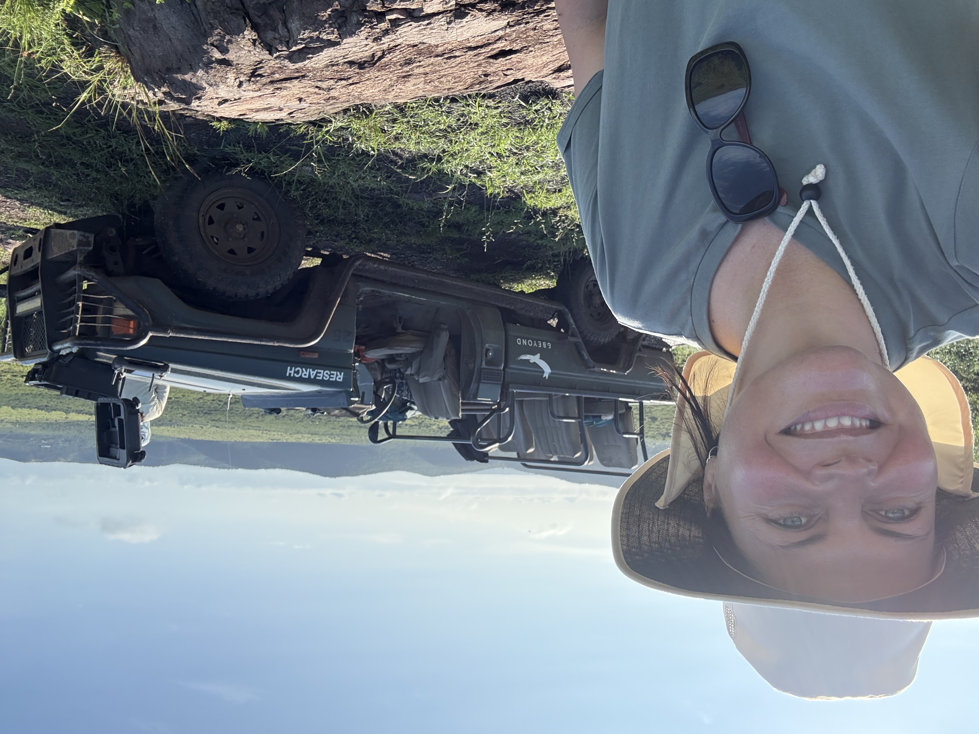 Michelle Jacobs - female volunteer posing next to the research vehicle 