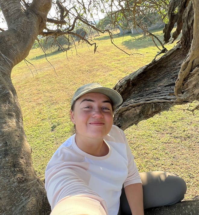 Isabella Drenthen - volunteer posing for a selfie on a tree
