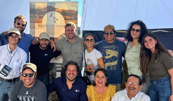 Moholoholo International Wildlife Summit 2025 Blog - Martial, manager of Moholoholo, posing with attendees of the summit