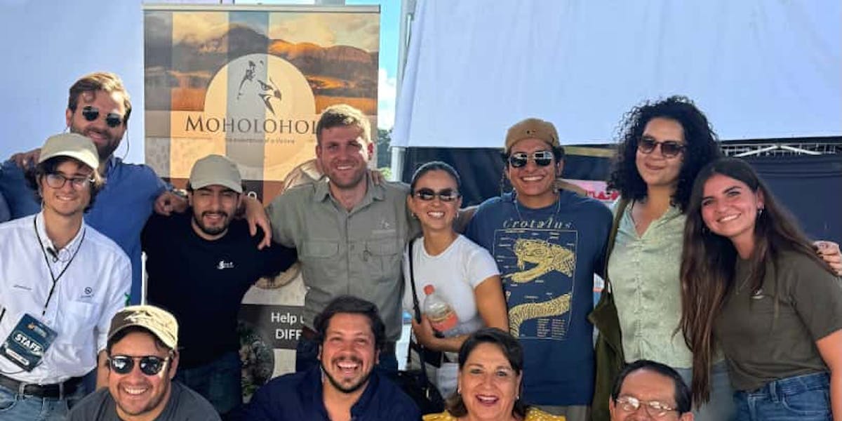 Moholoholo International Wildlife Summit 2025 Blog - Martial, manager of Moholoholo, posing with attendees of the summit