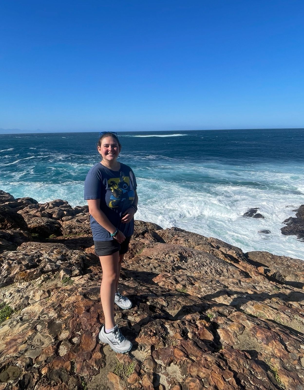 Volunteer standing in front of ocean