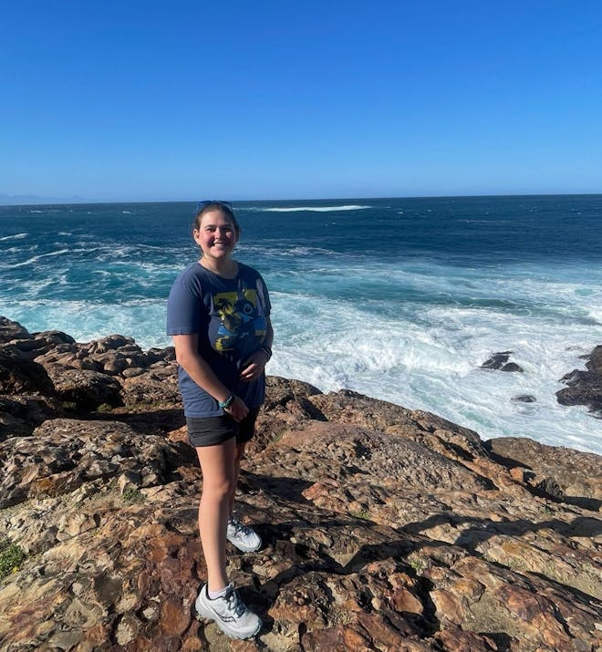 Volunteer standing in front of ocean