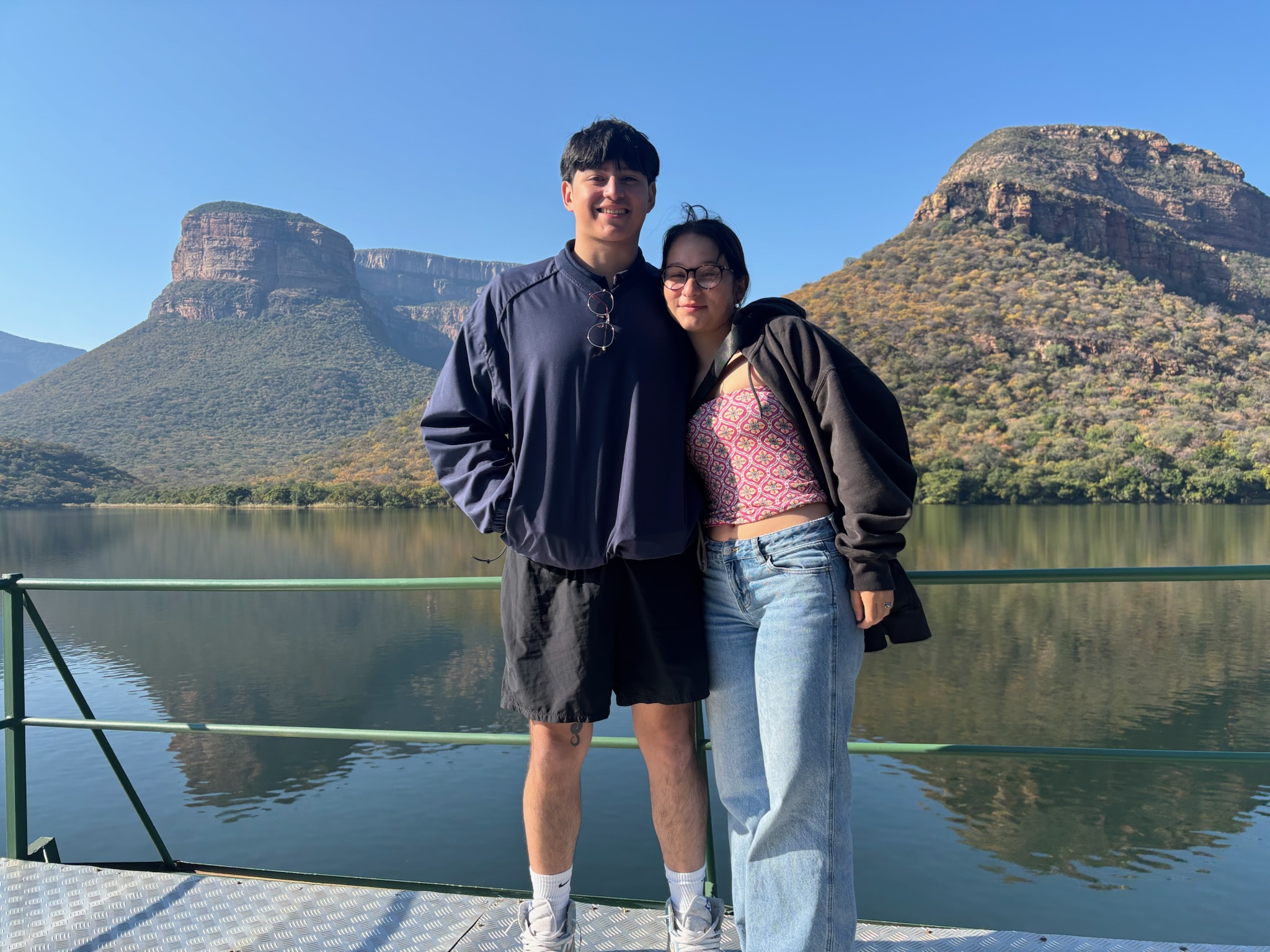 Lynda Amoa and Luis Rosales: couple posing together by the river 