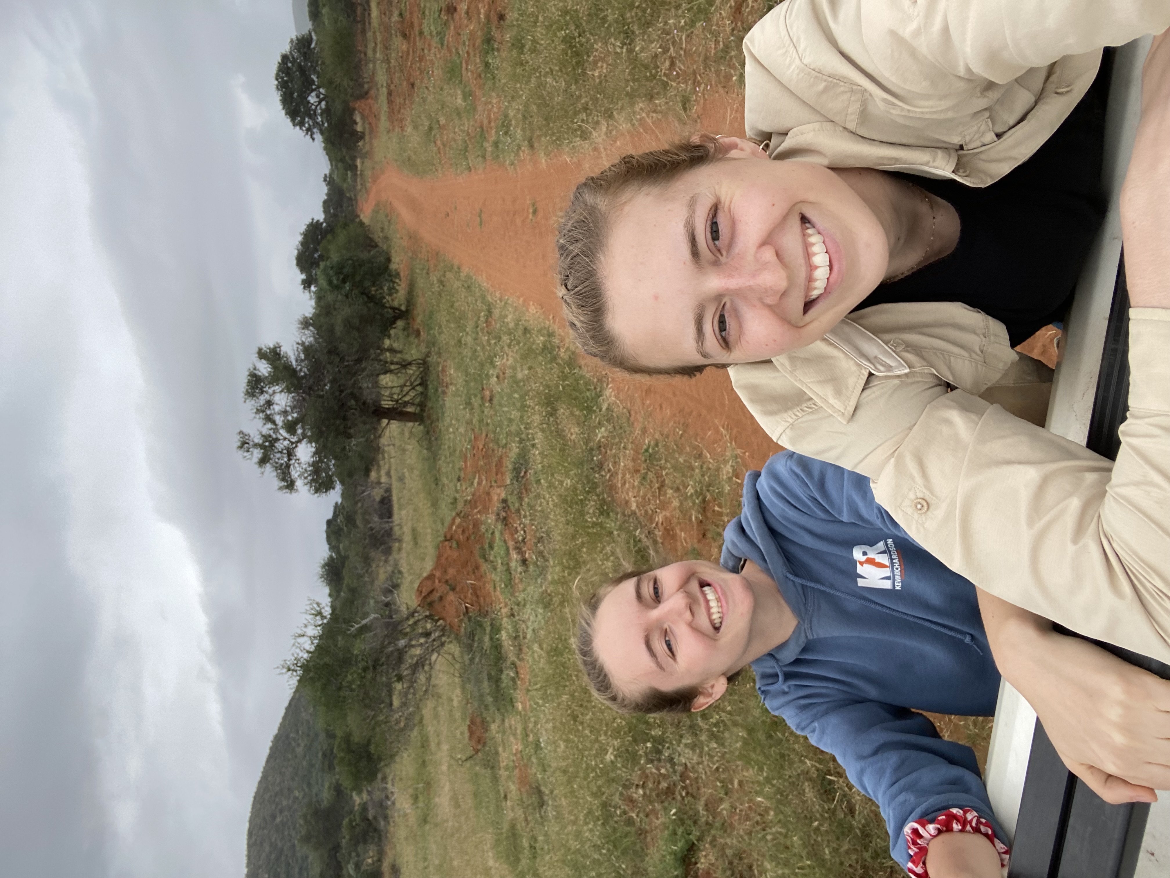 Maelis and Madeline - Two female volunteers on back of vehicle
