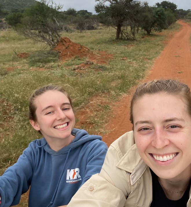 Maelis and Madeline - Two female volunteers on back of vehicle
